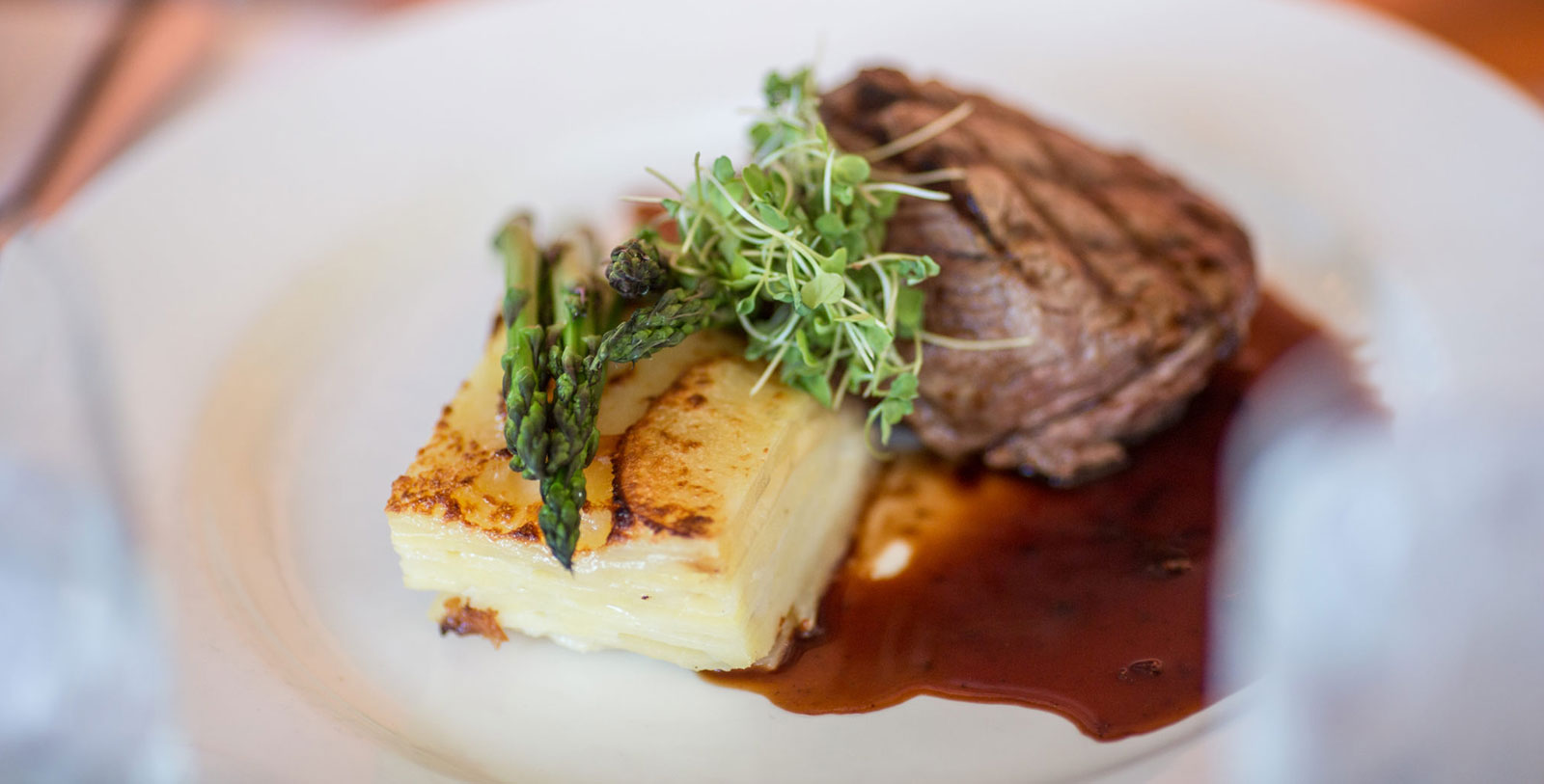a plate of food with asparagus and potatoes