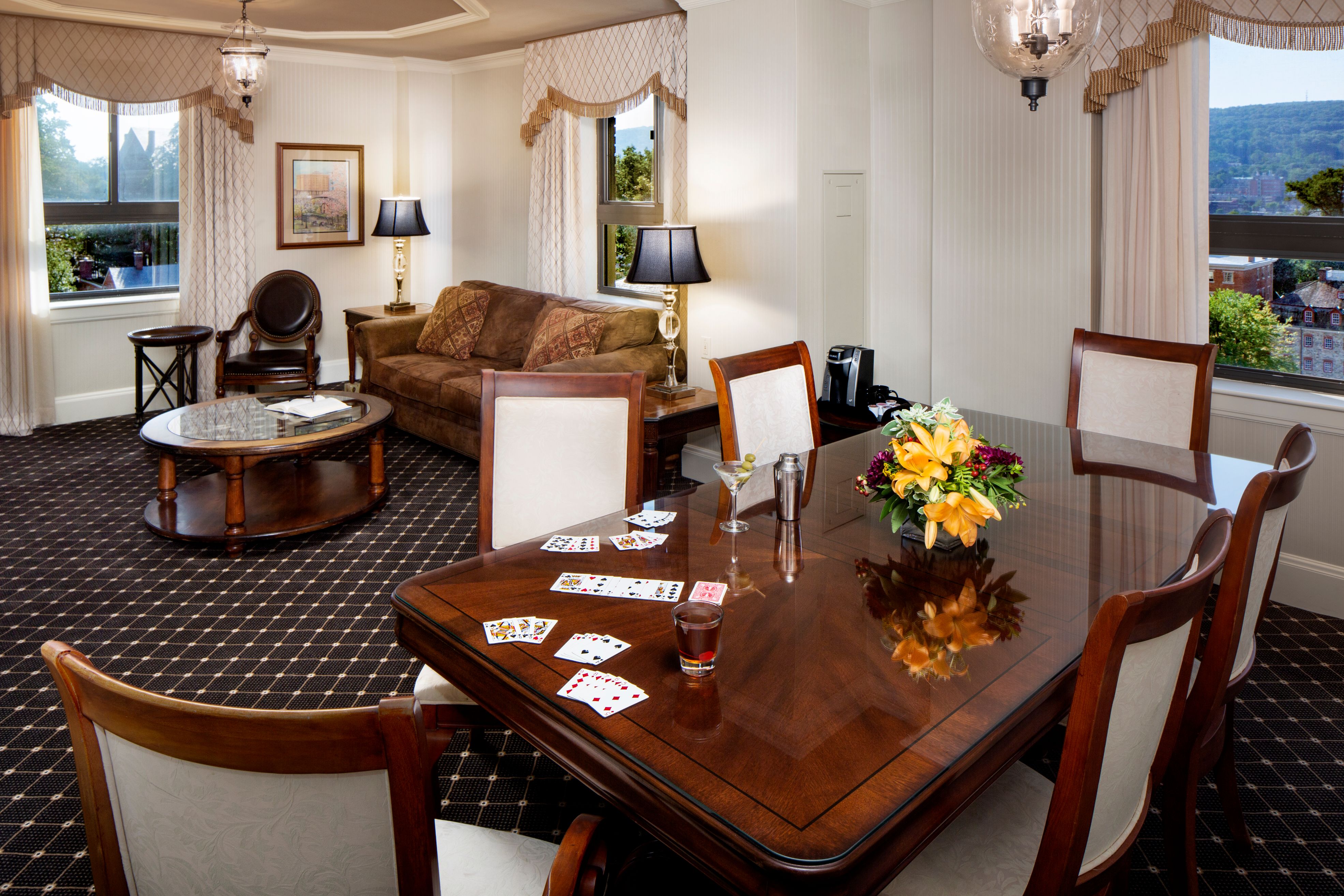 a room with a table and chairs and a couch