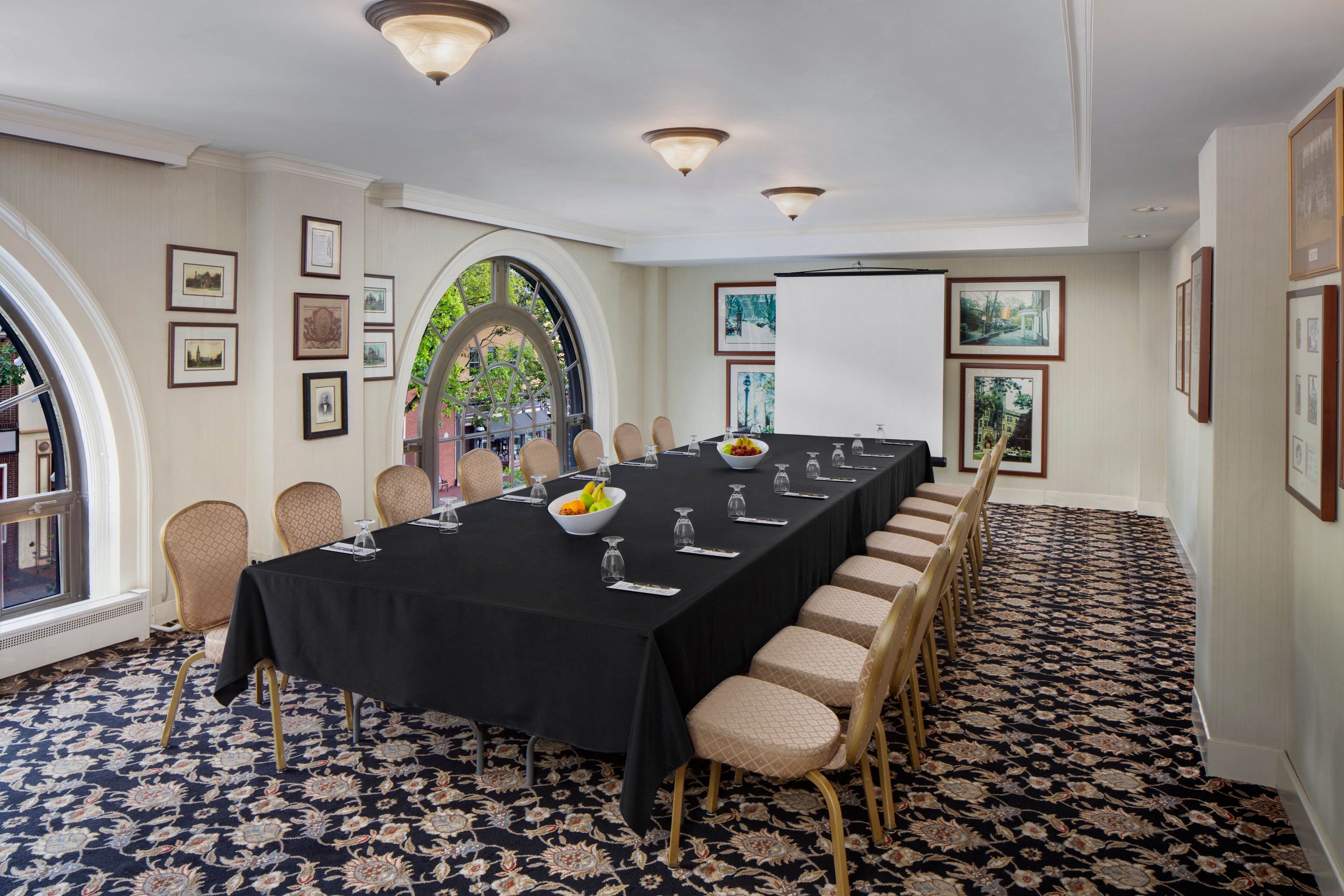 a room with a long table and chairs