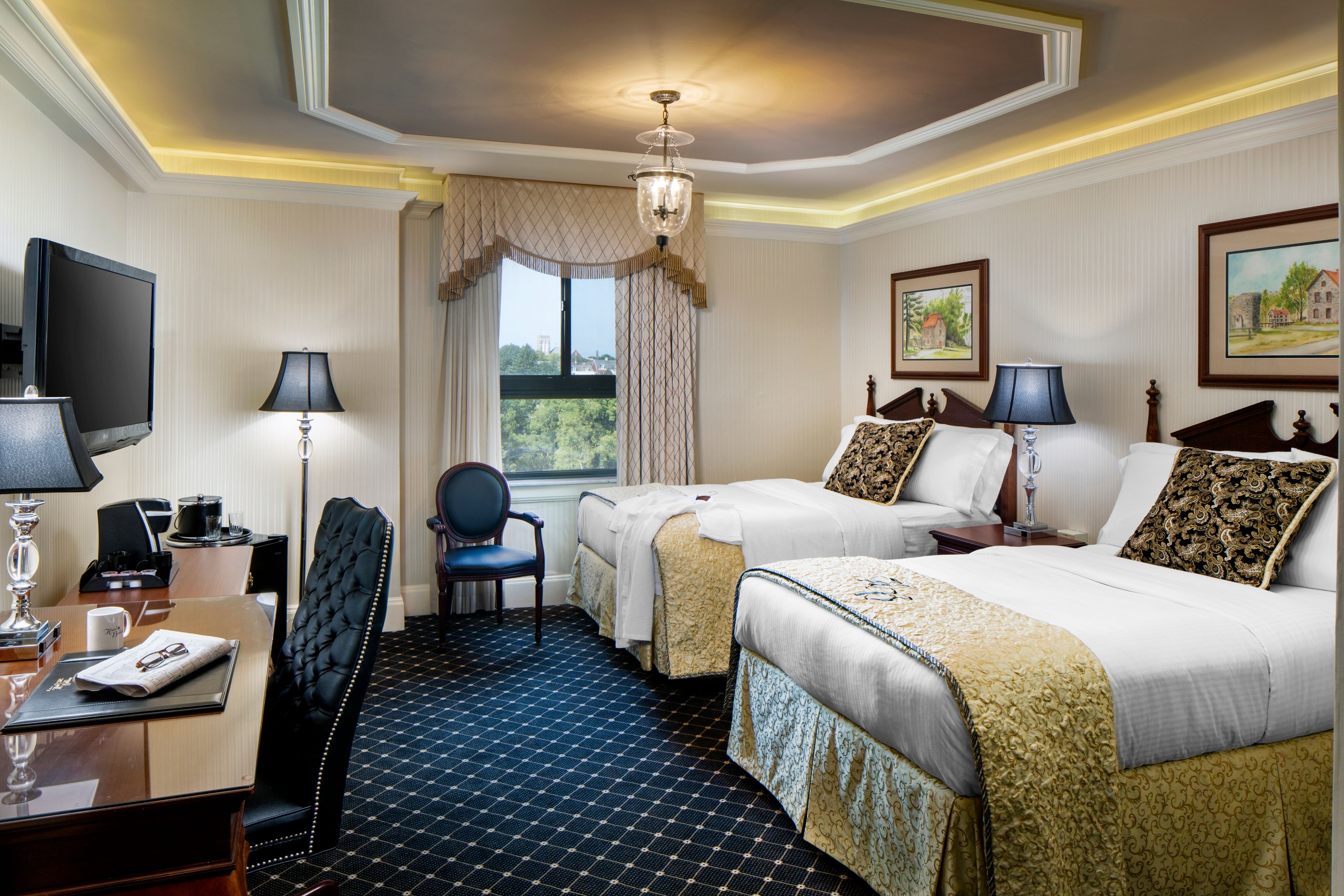 a room with two beds and a desk