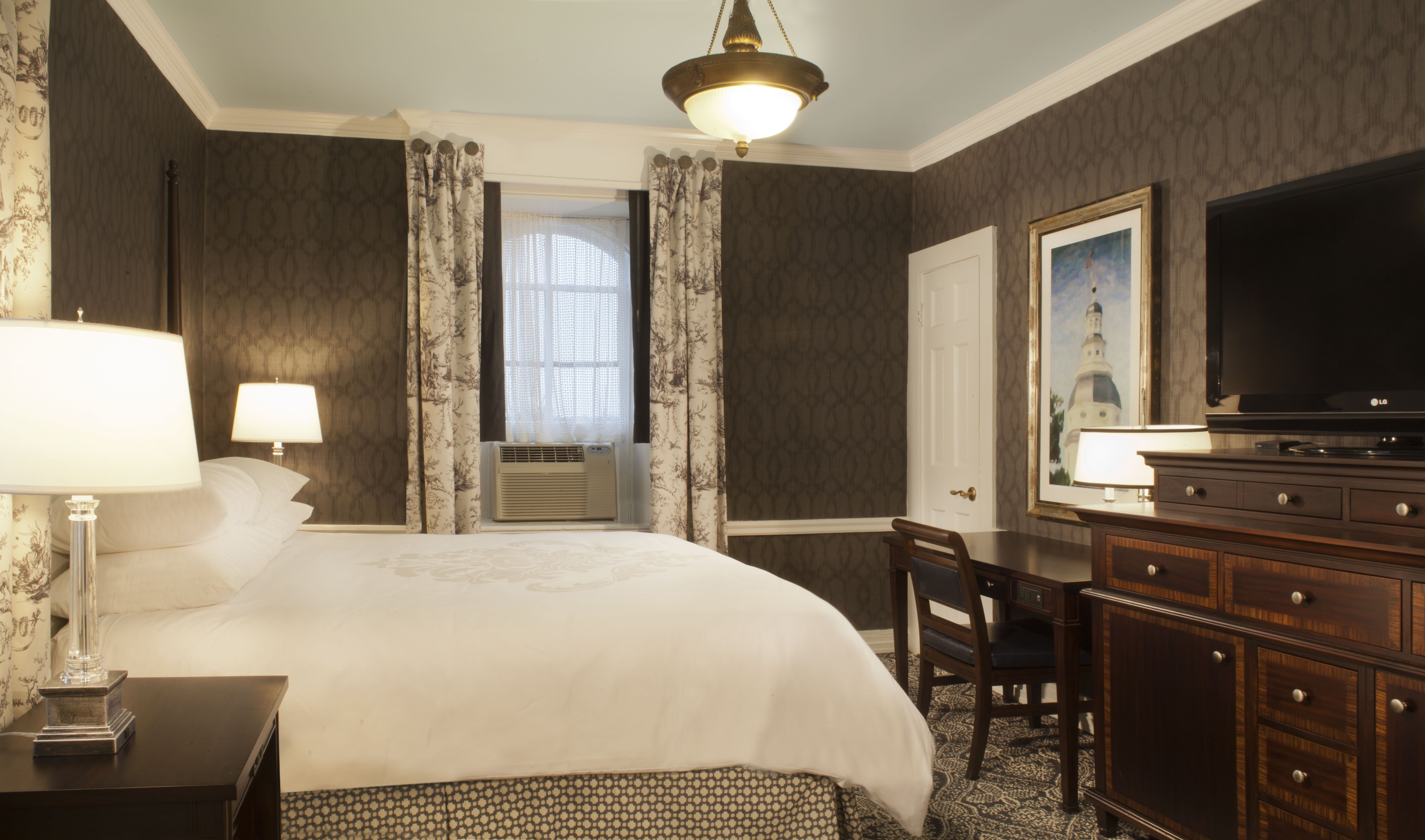 a room with a bed and a desk