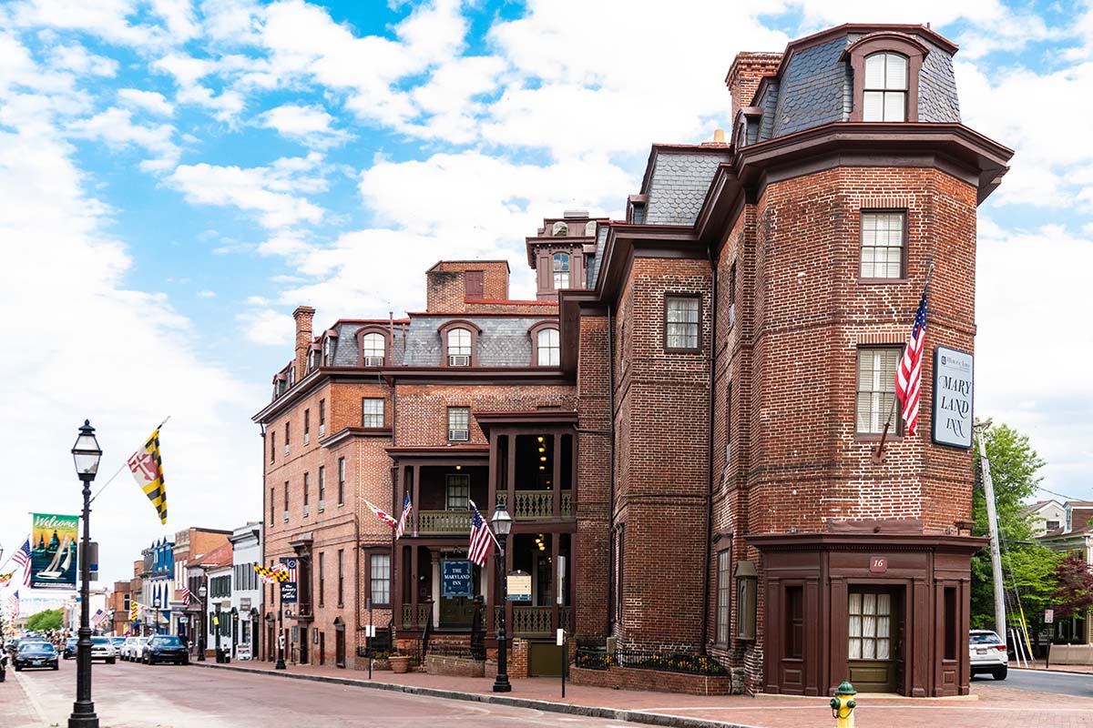 a brick building with flags on the side of the street