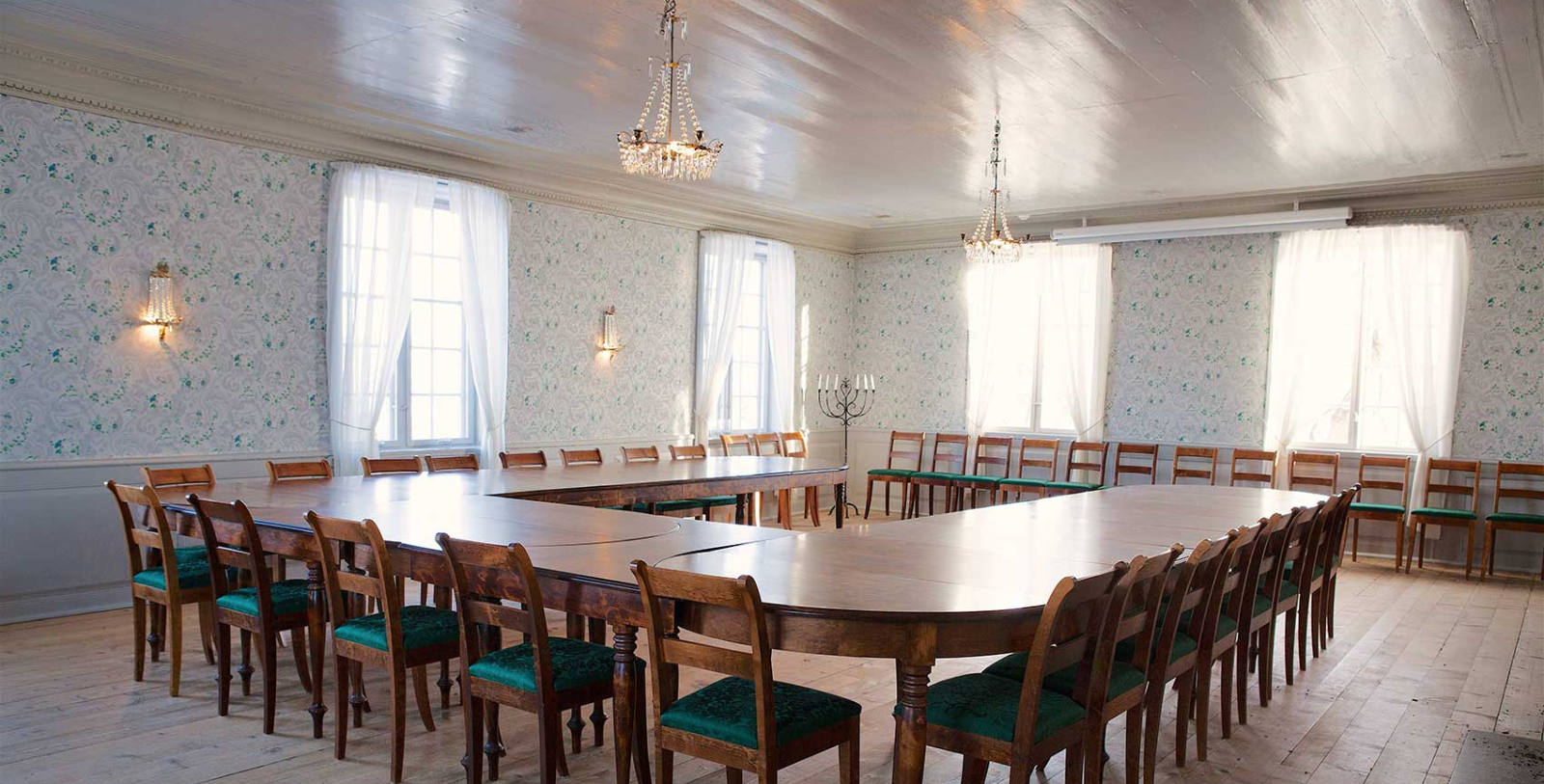 a room with a large table and chairs