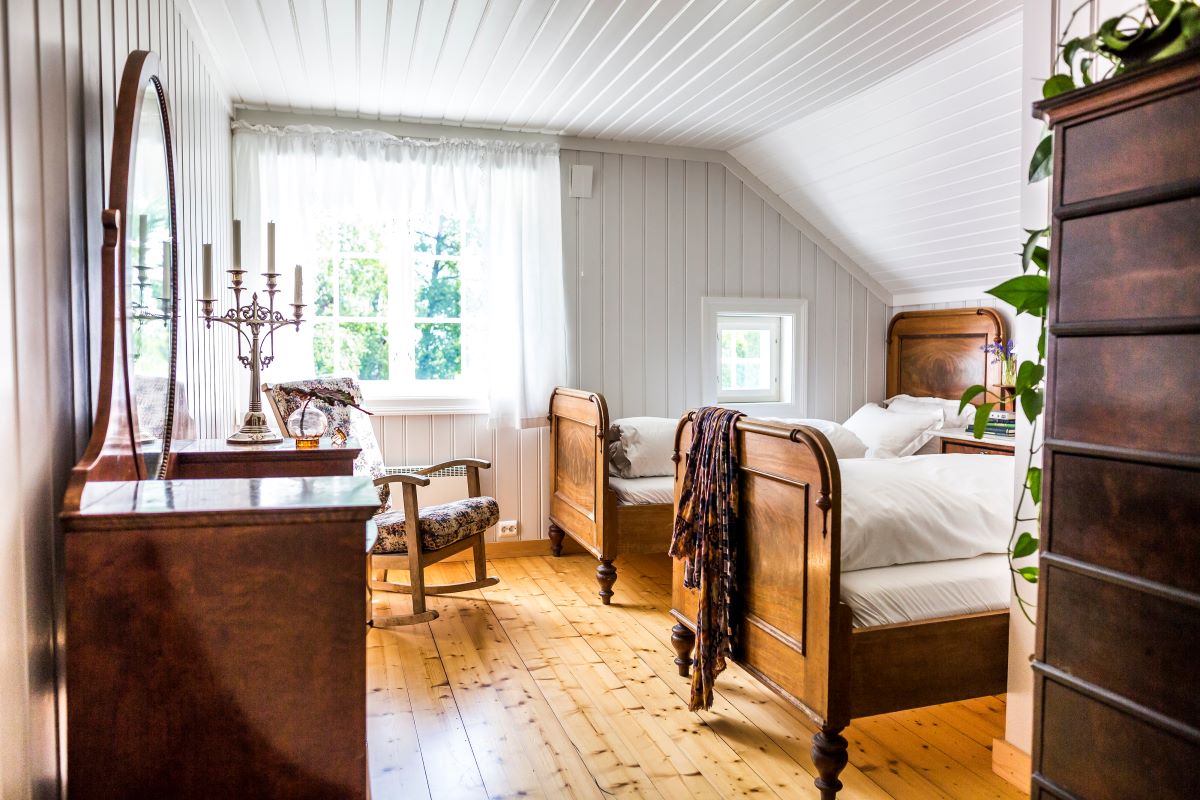 a room with two beds and a desk