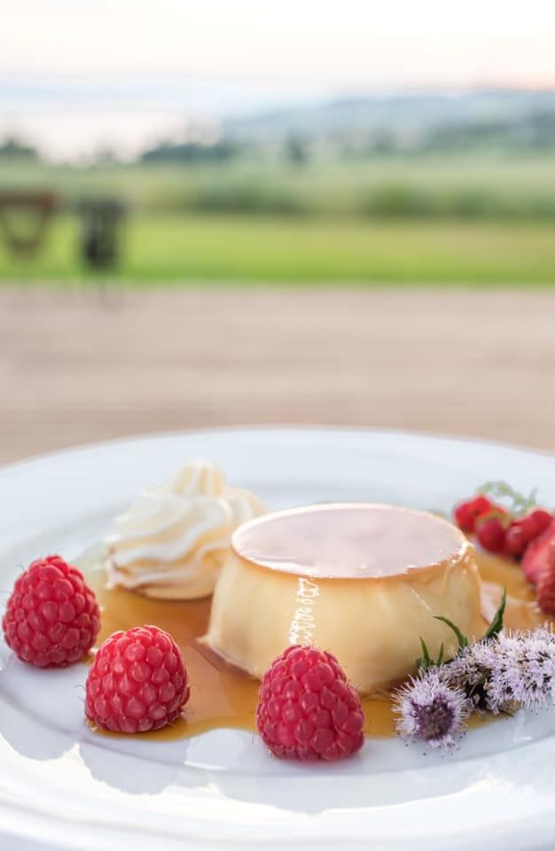 a plate of dessert with raspberries and whipped cream