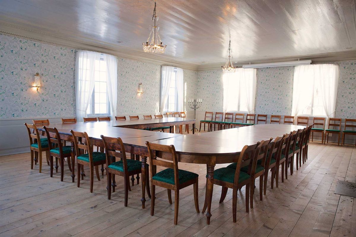 a large conference room with a table and chairs