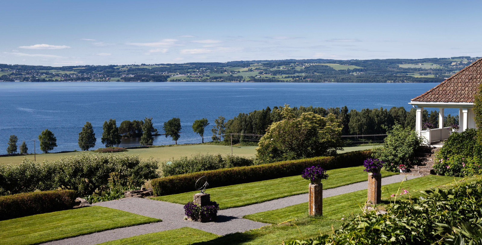 a landscape with a body of water and a body of water in the background