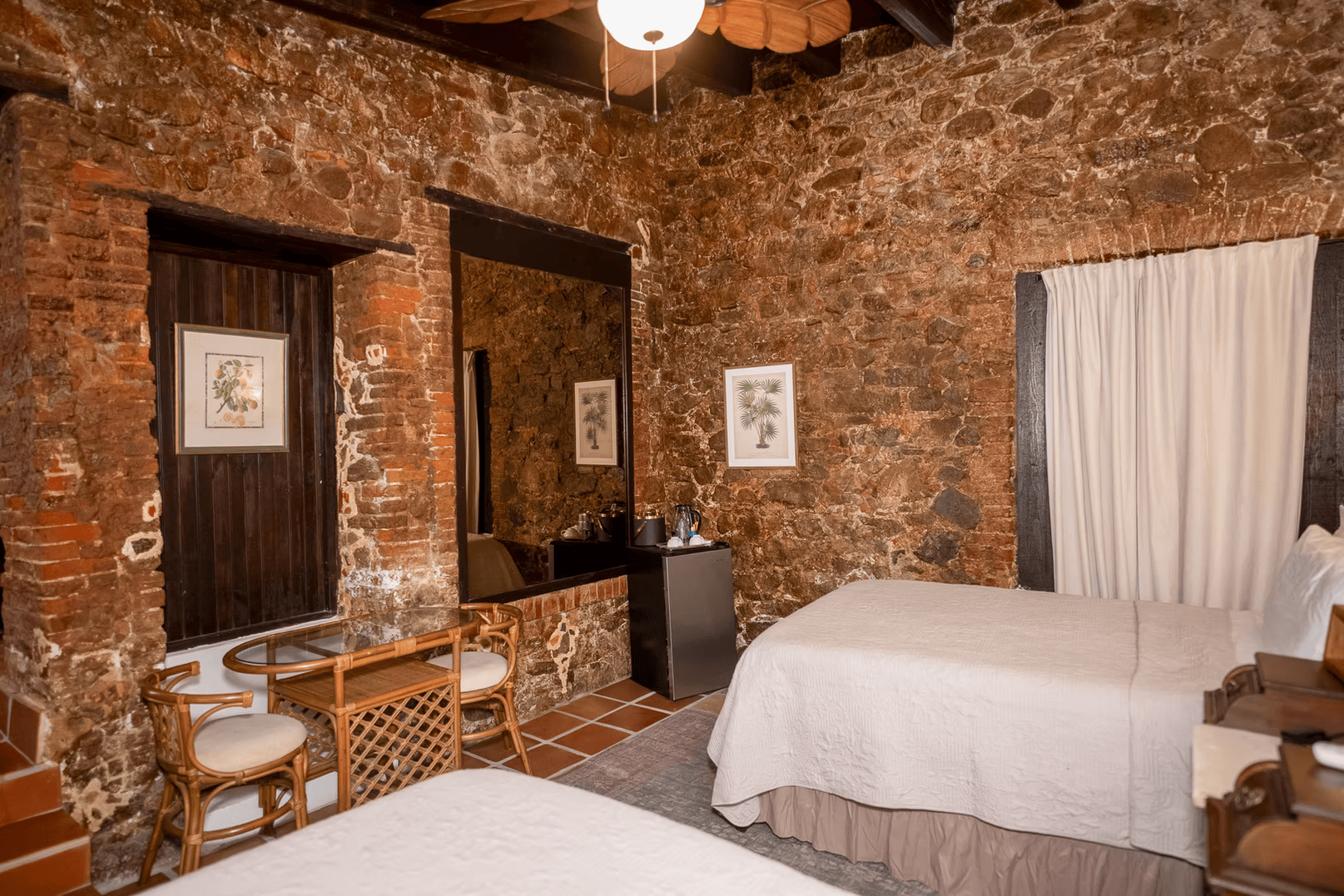 a room with a stone wall and a bed