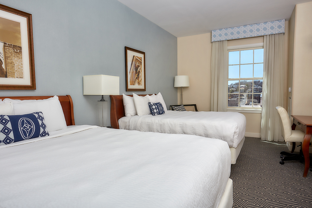 a room with two beds and a window