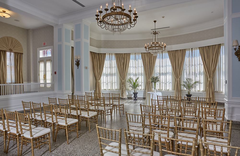 a room with chairs and chandeliers