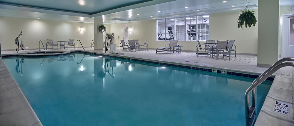 a swimming pool with chairs and a chair in the middle