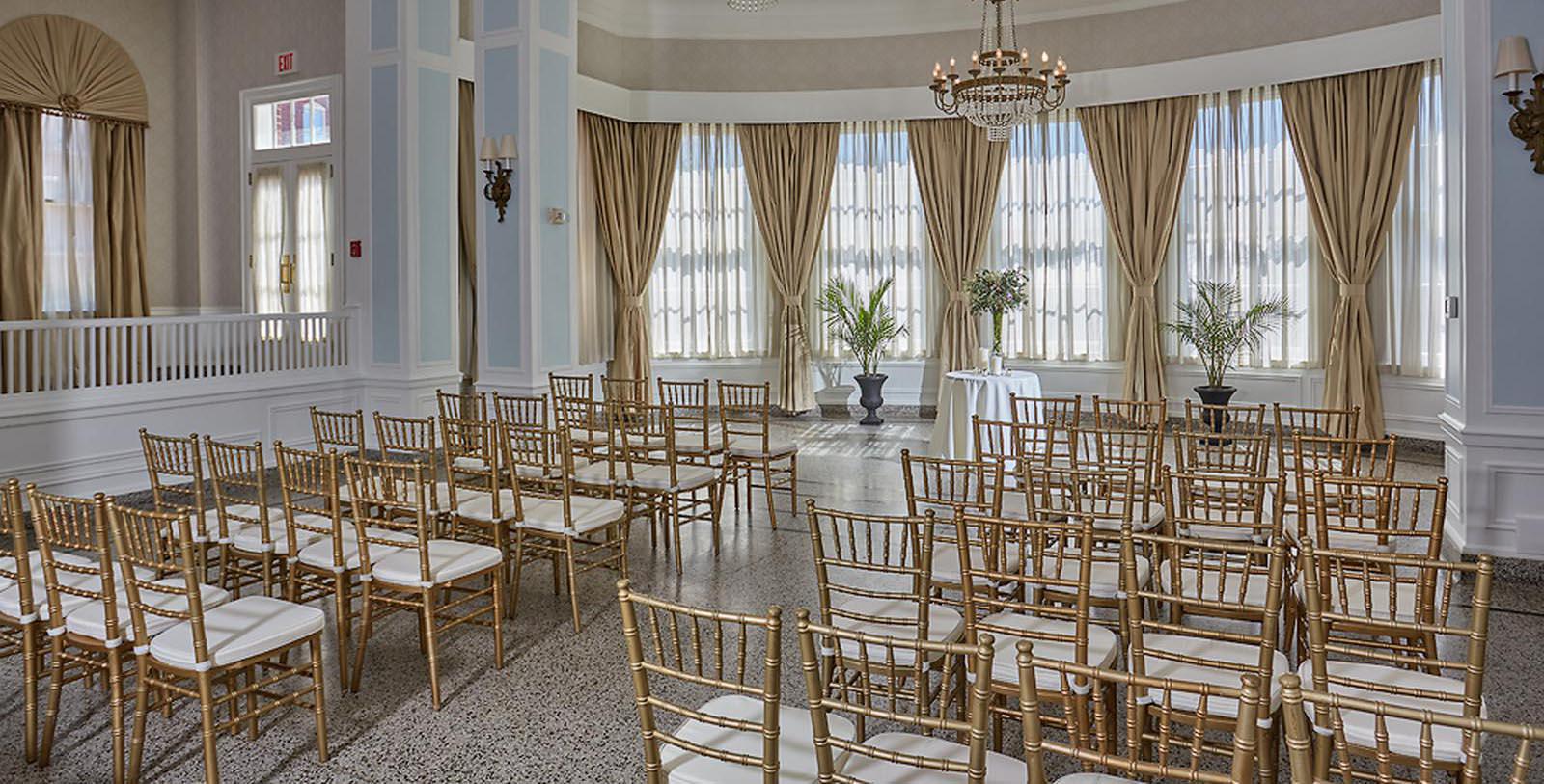 a room with chairs and chandelier