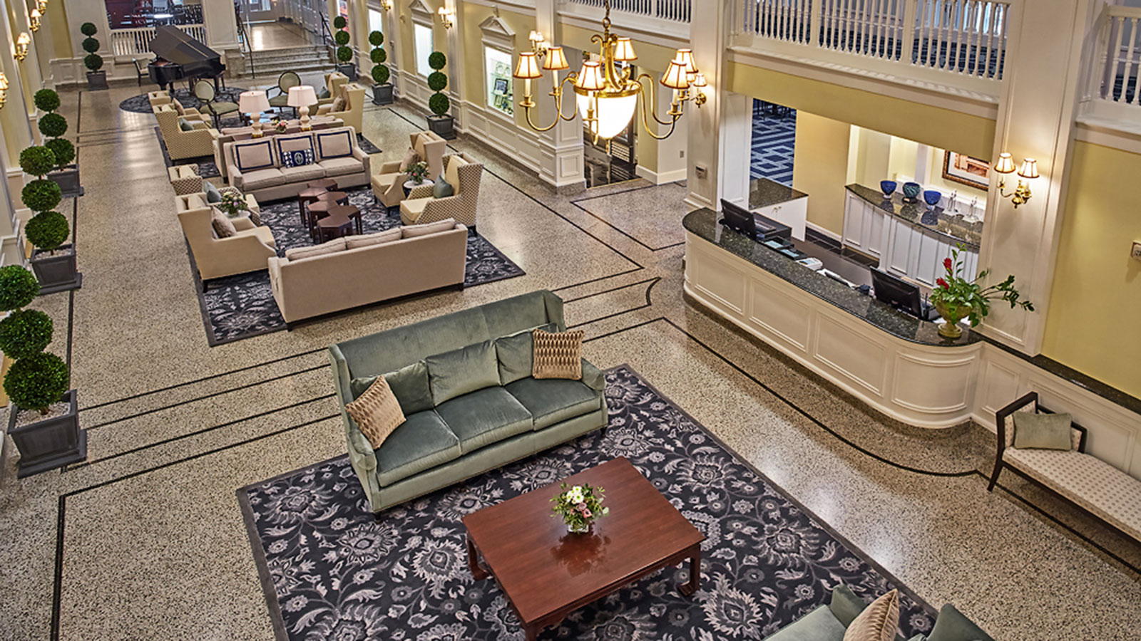 a large lobby with a large reception desk and couches