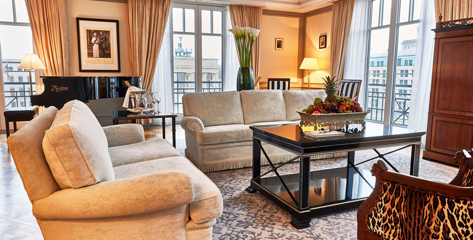 a living room with couches and a piano