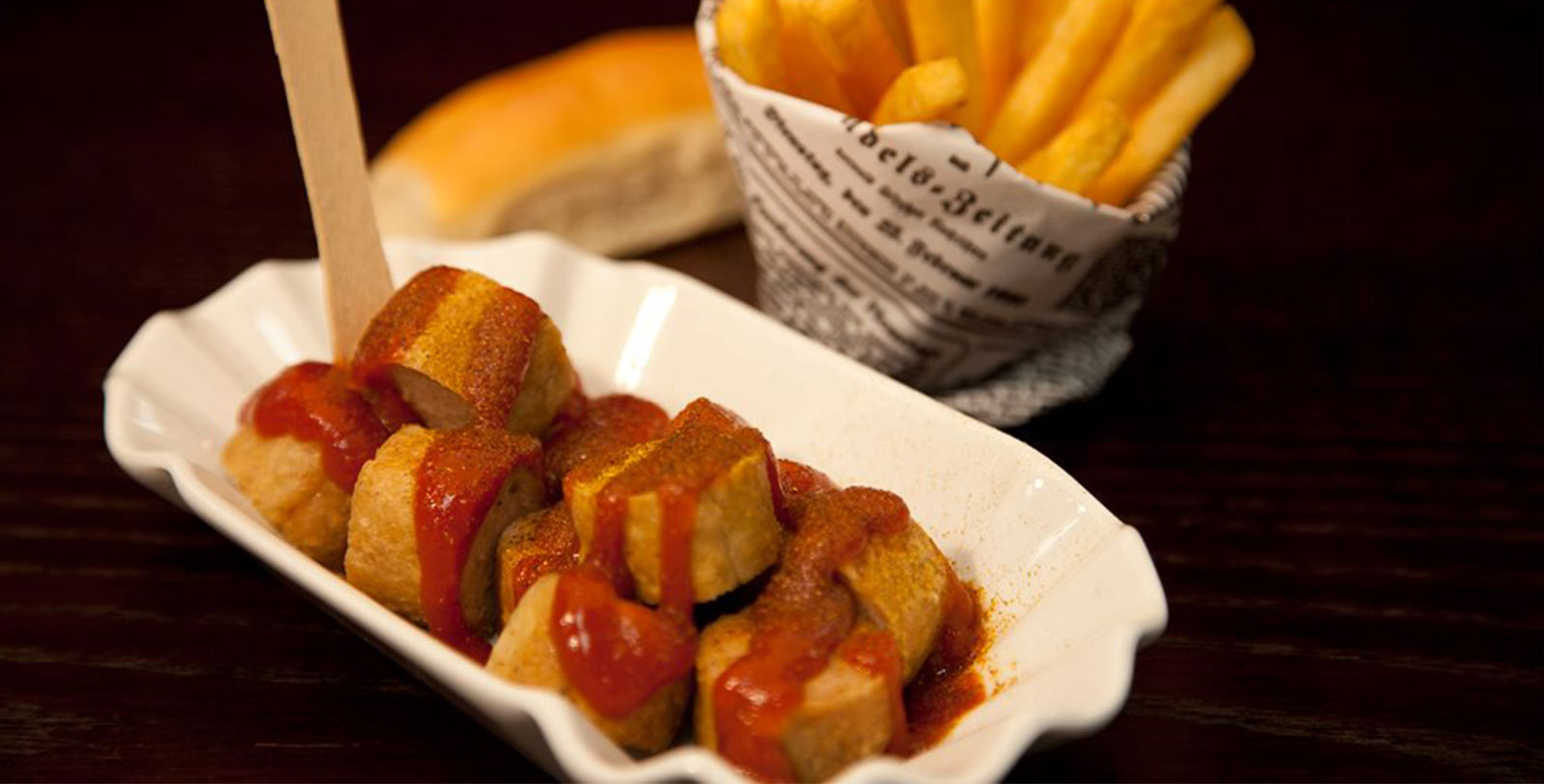 a plate of food next to a basket of french fries