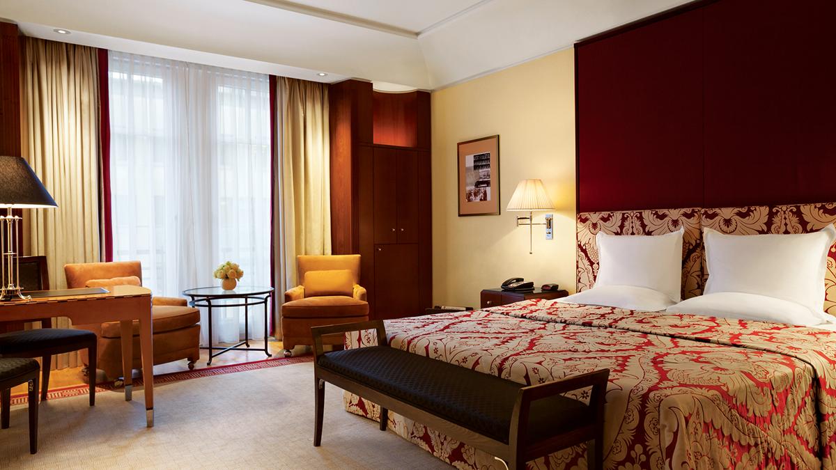 a room with a bed and chairs