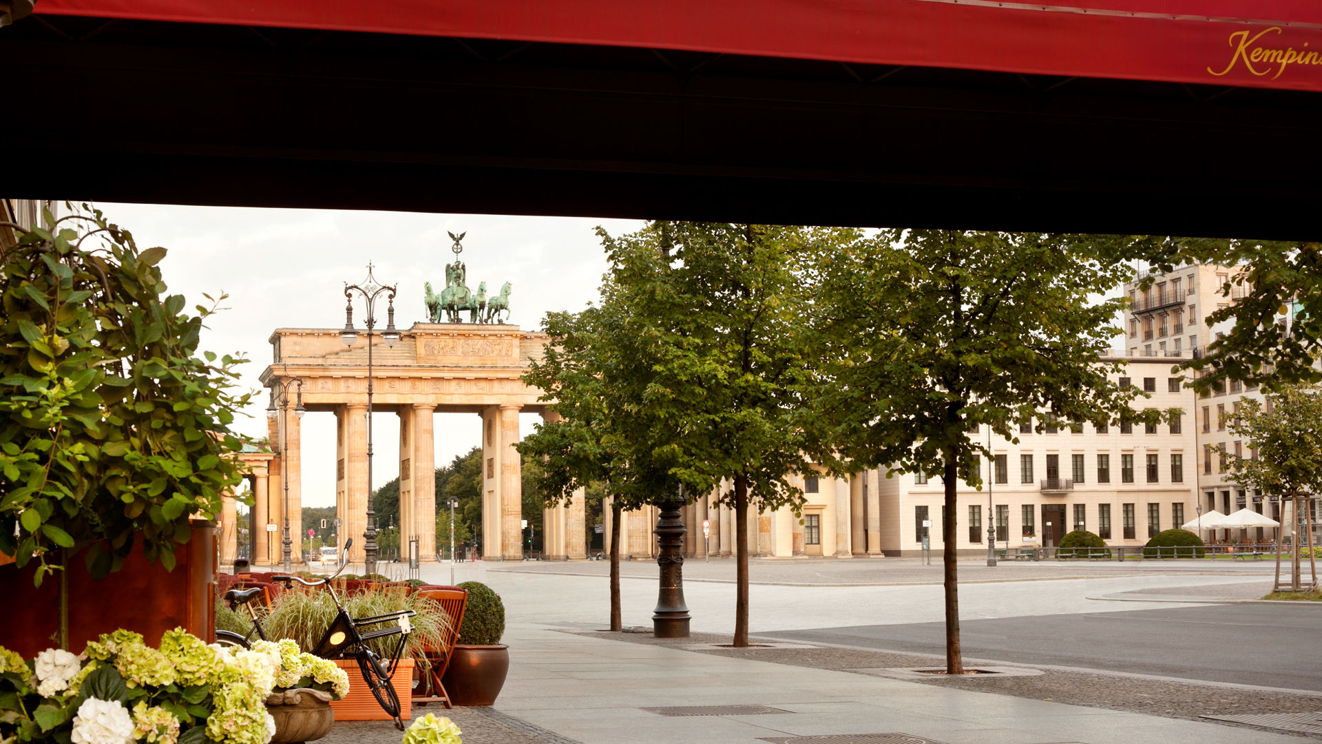 a large building with columns and a statue in the background