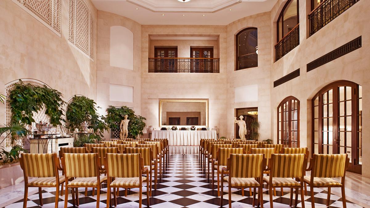 a room with chairs and a black and white checkered floor