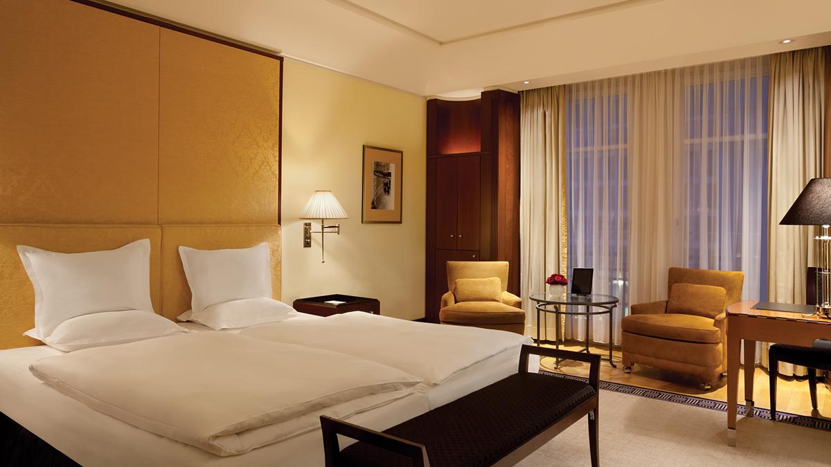 a hotel room with a bed and chairs