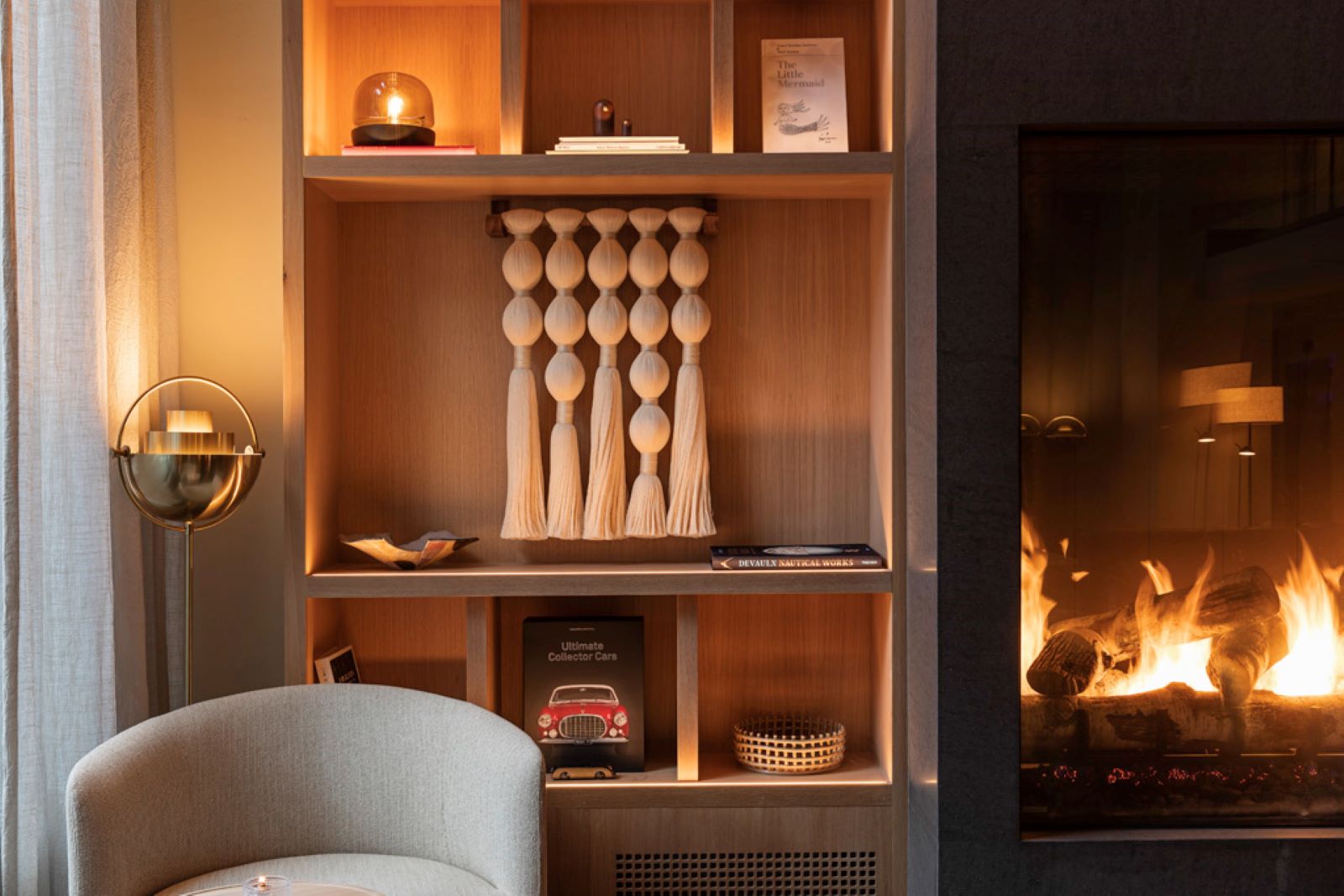 a shelf with a fireplace and a lamp