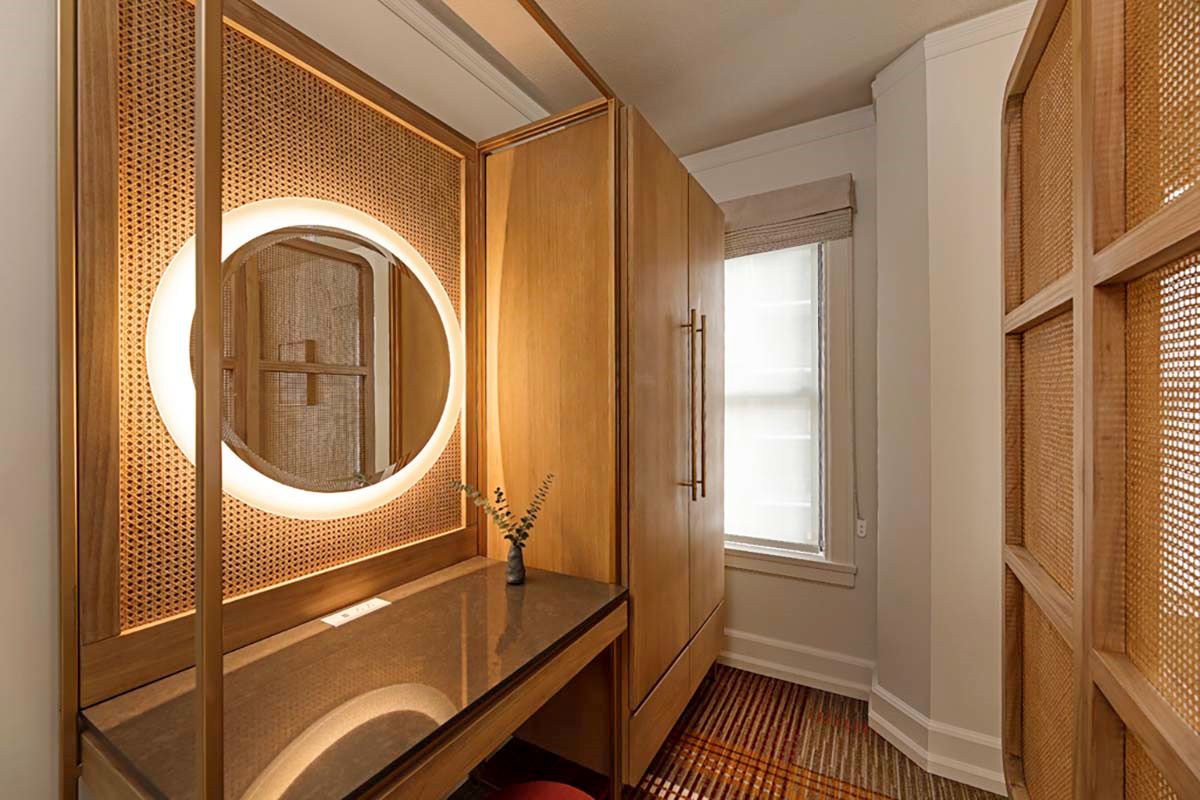 a room with a mirror and cabinets