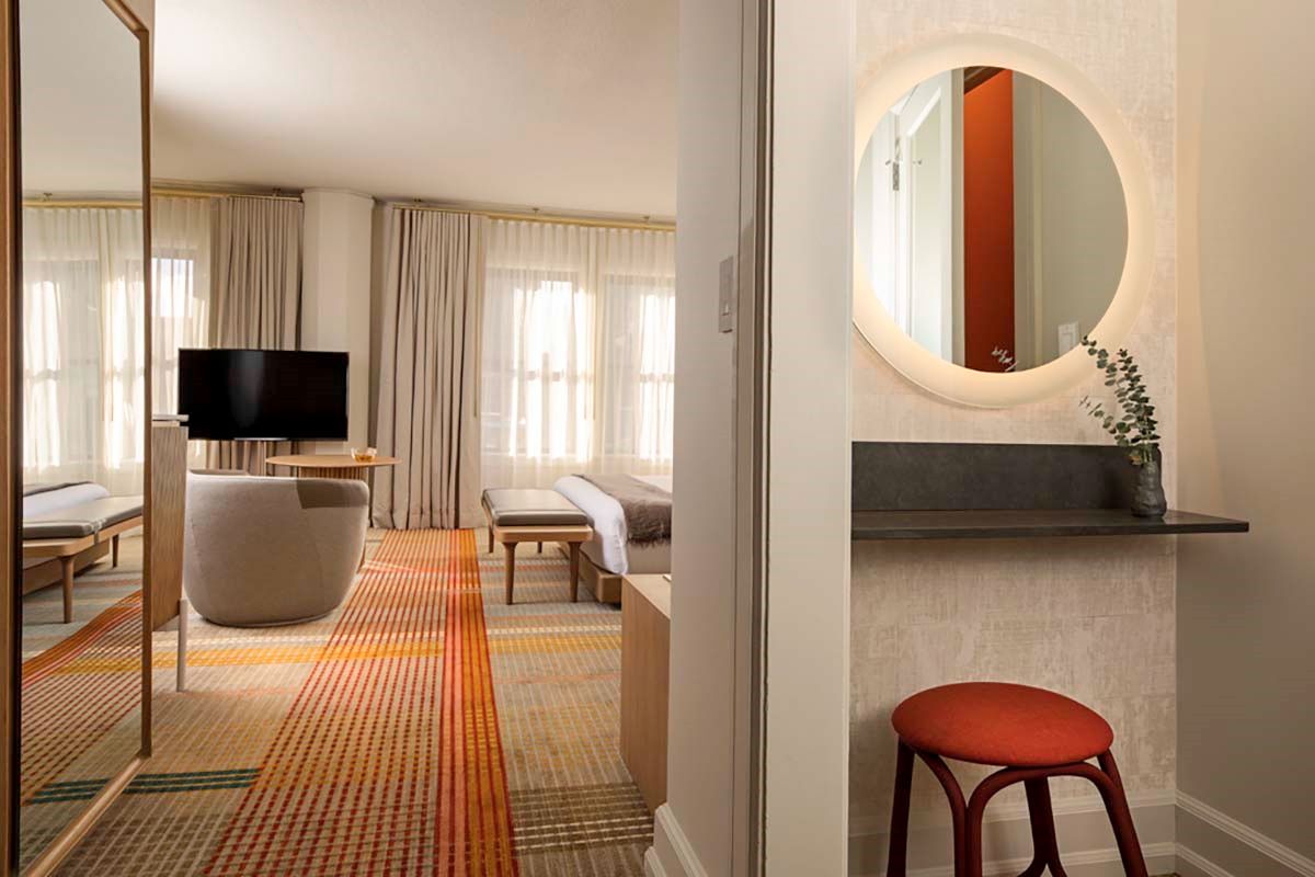 a room with a round mirror and a television