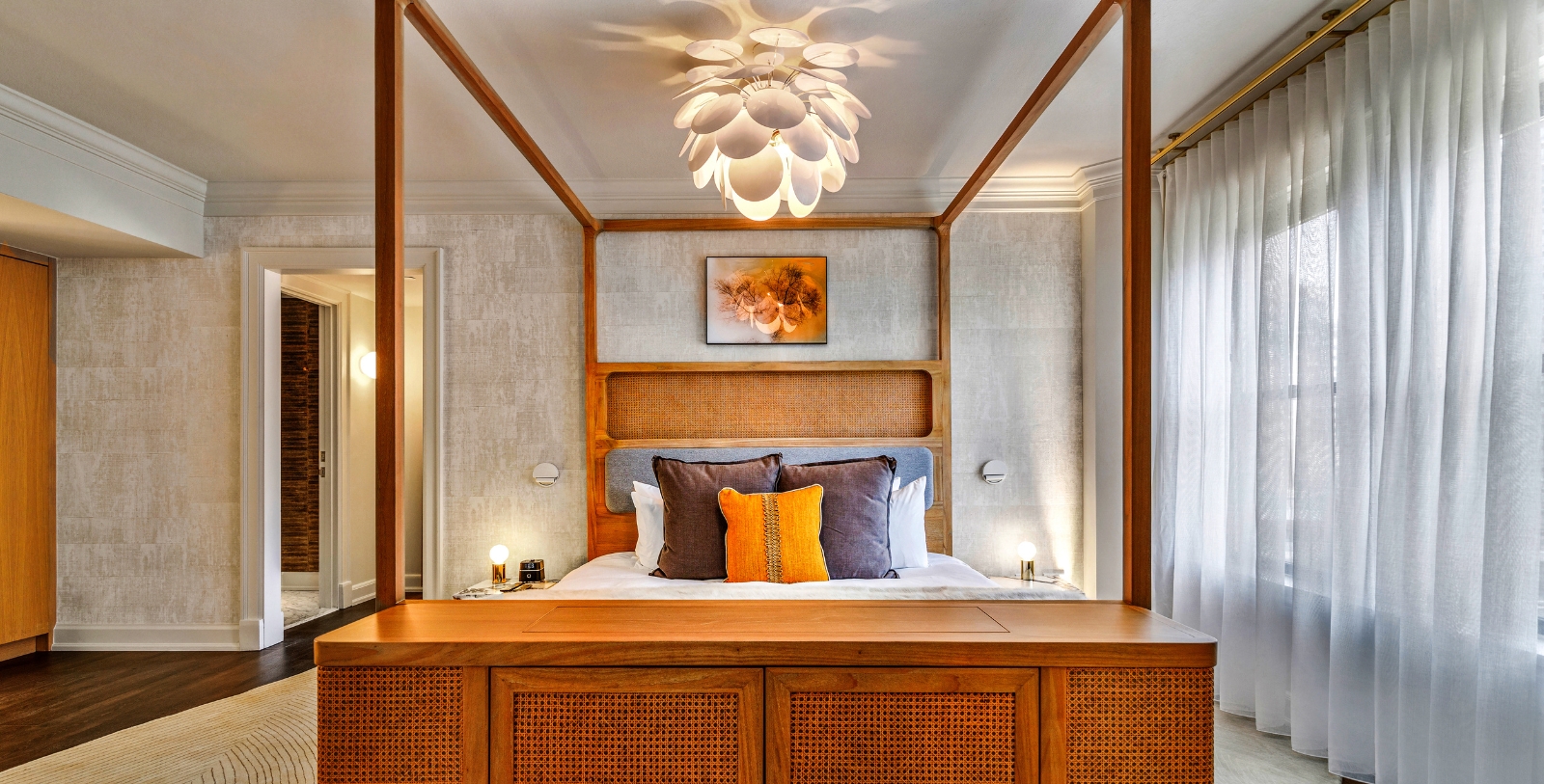 a bed with a wooden headboard and a light fixture