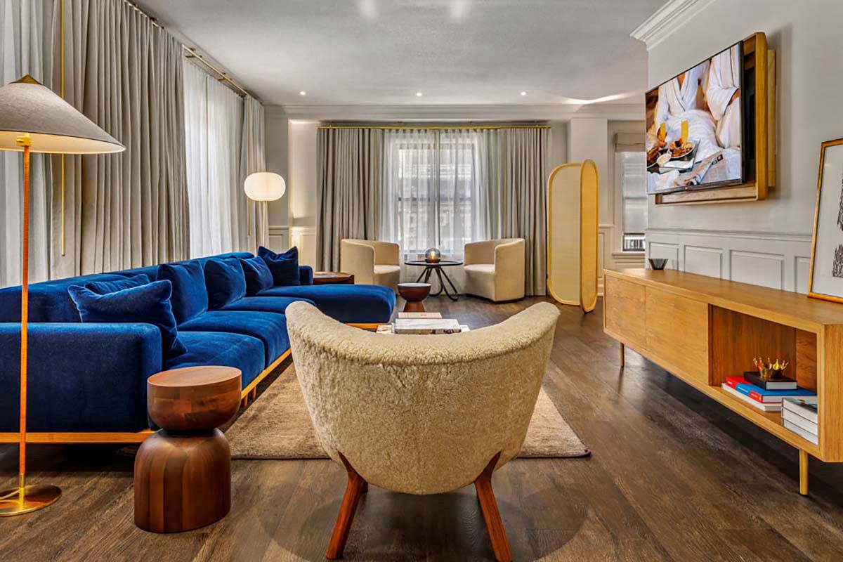 a living room with a blue couch and a tv