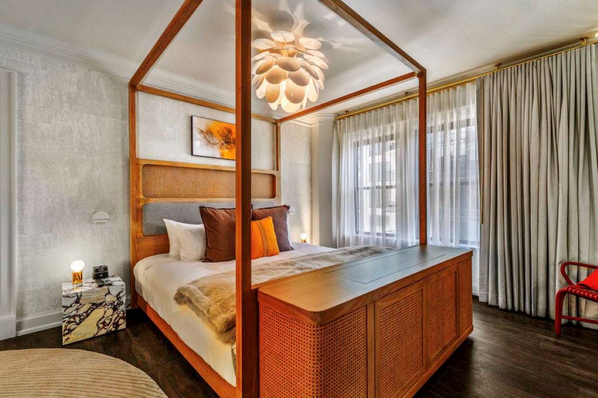 a bed with a wooden canopy