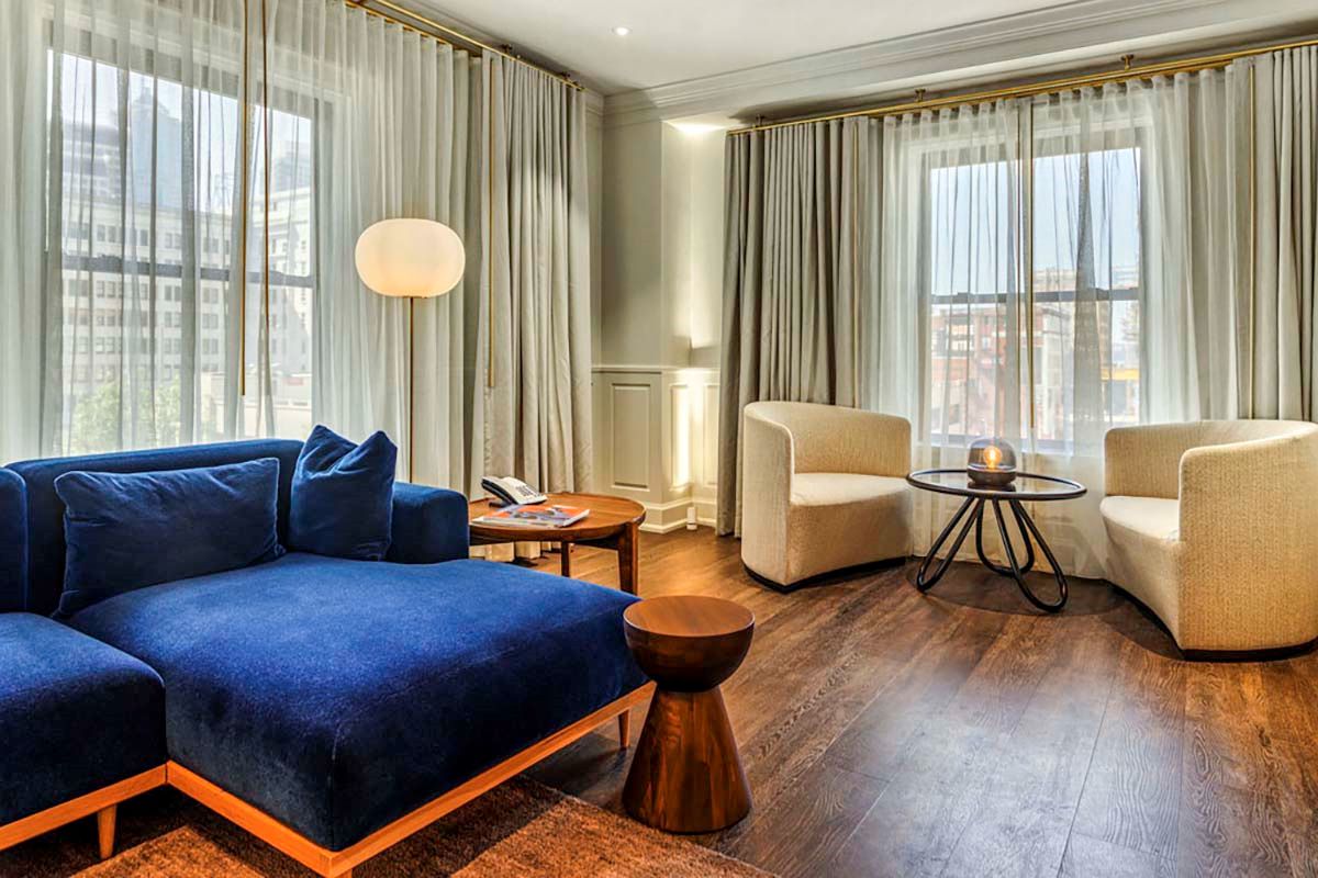 a room with a couch and chairs