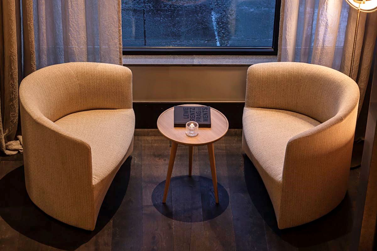 two chairs next to a small table