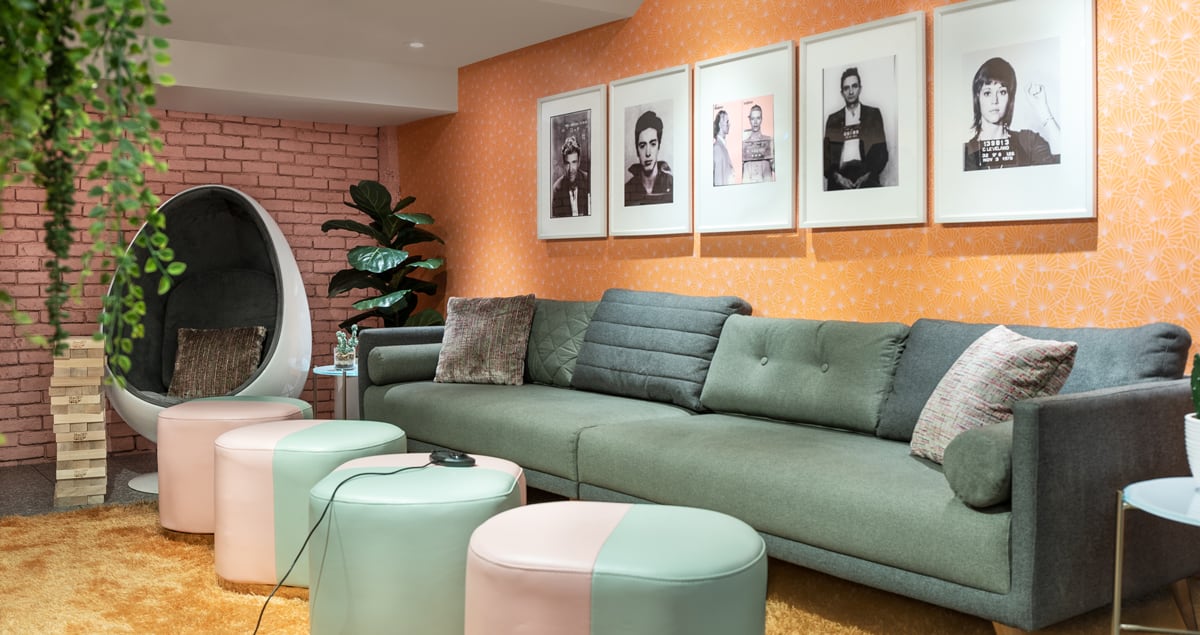 a living room with a couch and stools