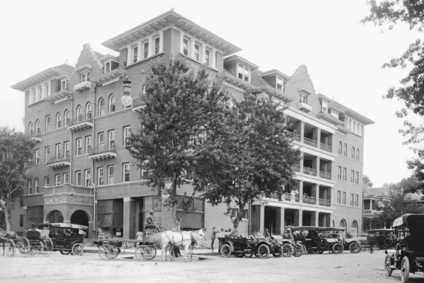 a horse drawn carriages parked in front of a large building