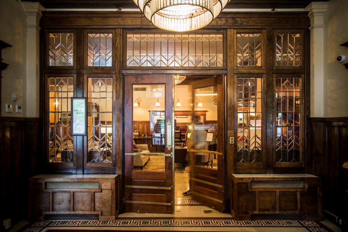 a door with glass panels and a person in the background