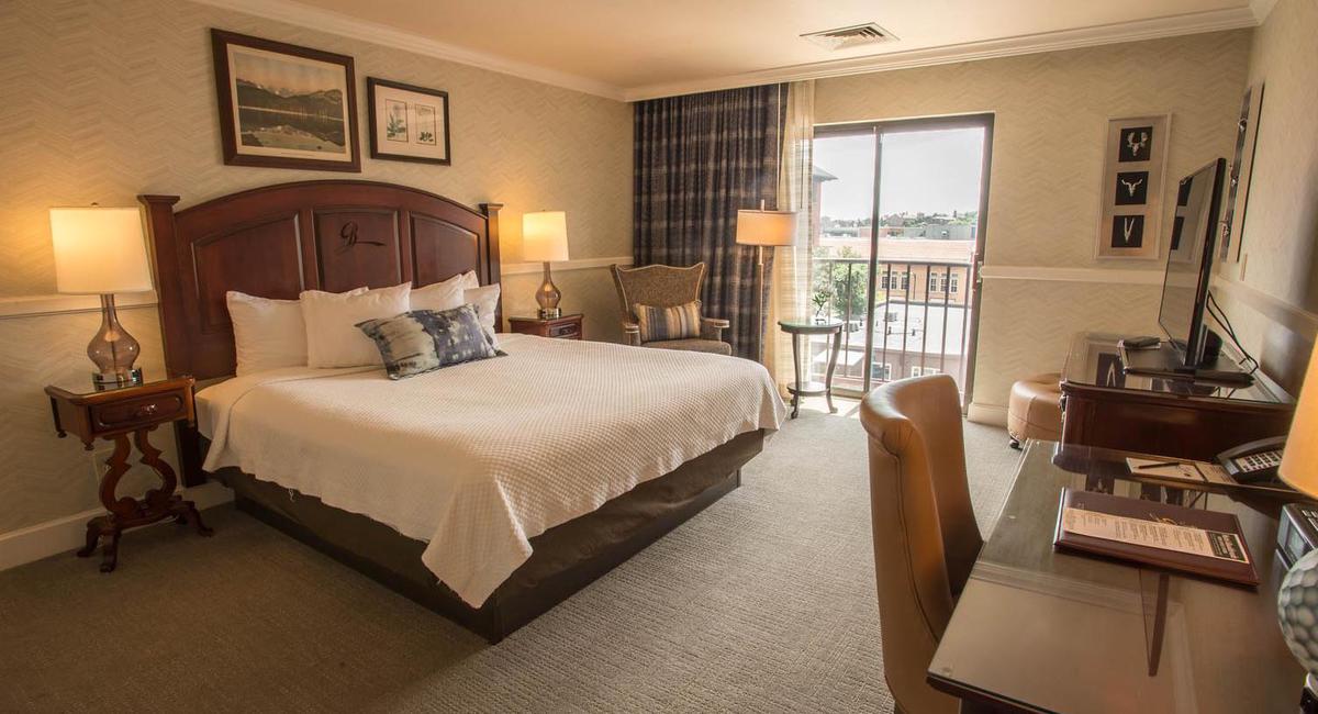 a bedroom with a bed and a desk