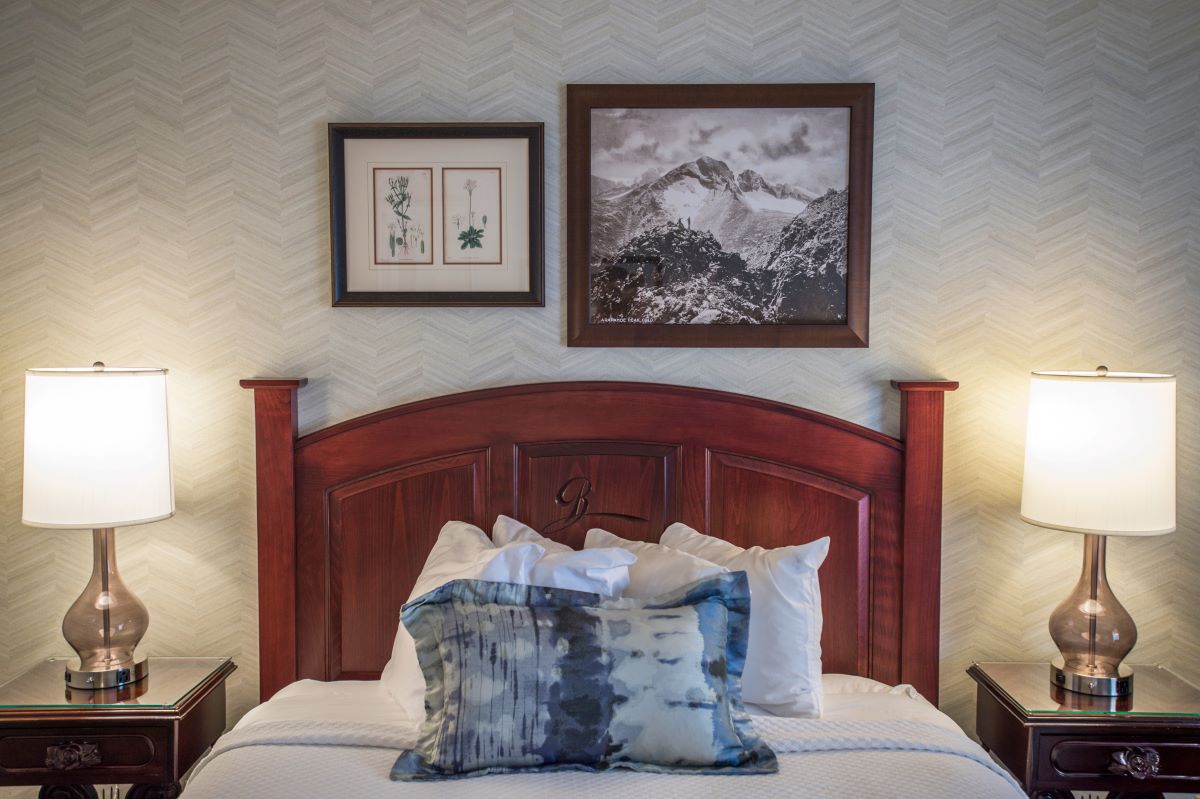 a bed with a picture on the wall