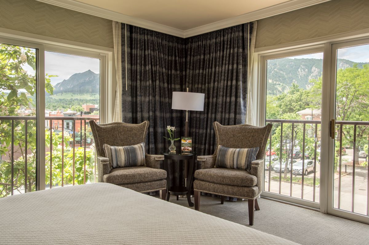 a room with a bed and chairs