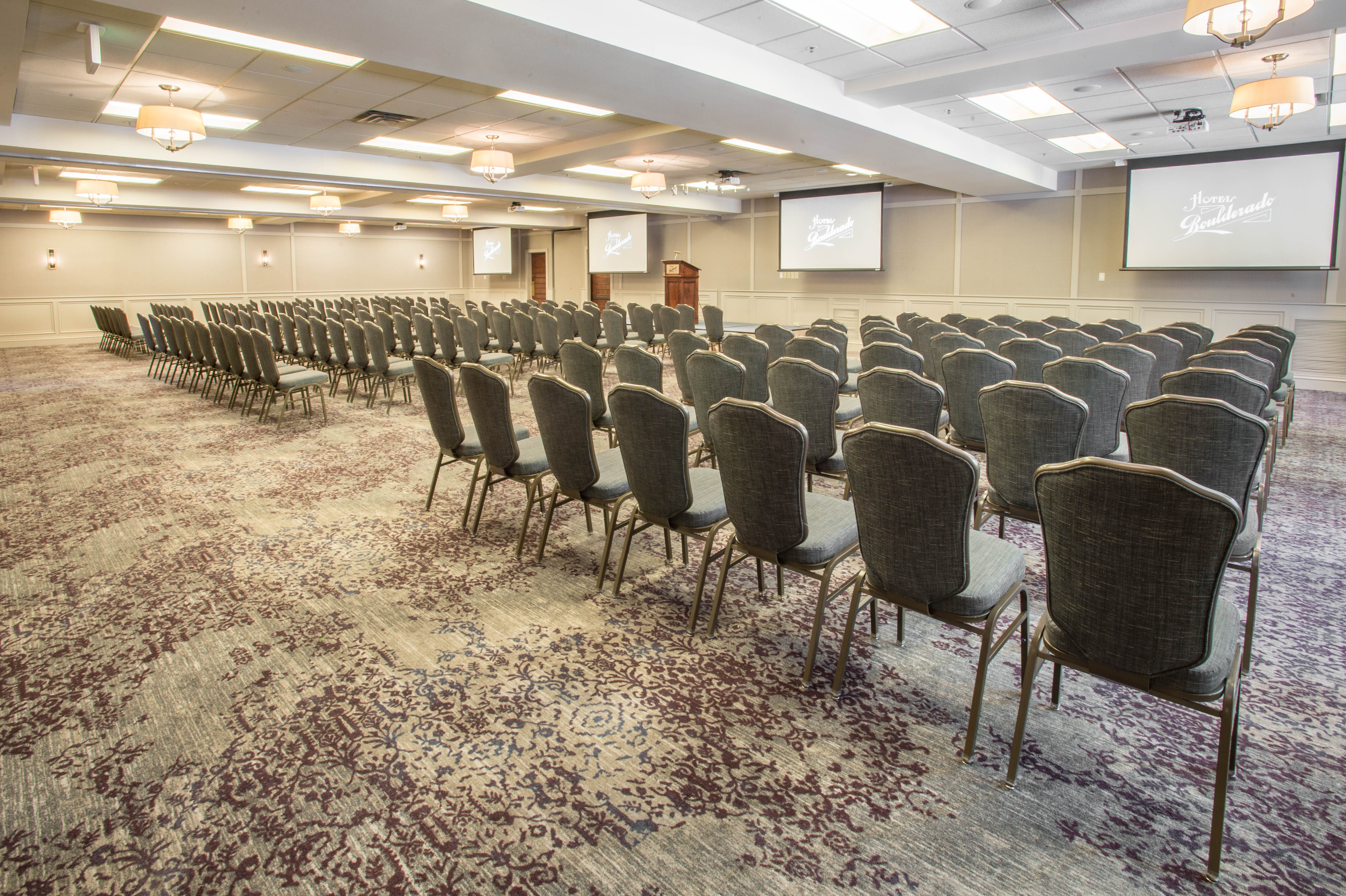 a large room with chairs and a podium