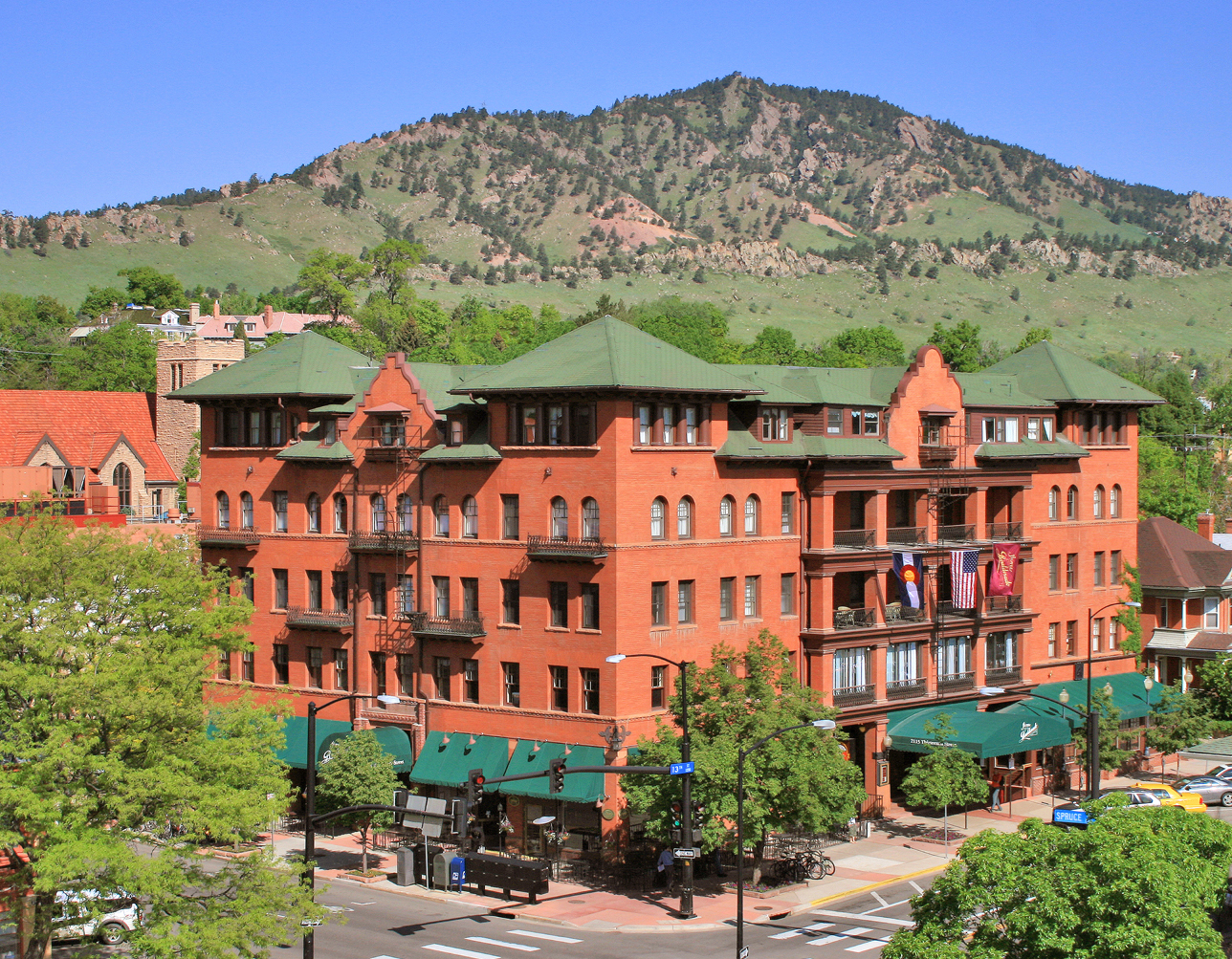 a building with trees and mountains in the background