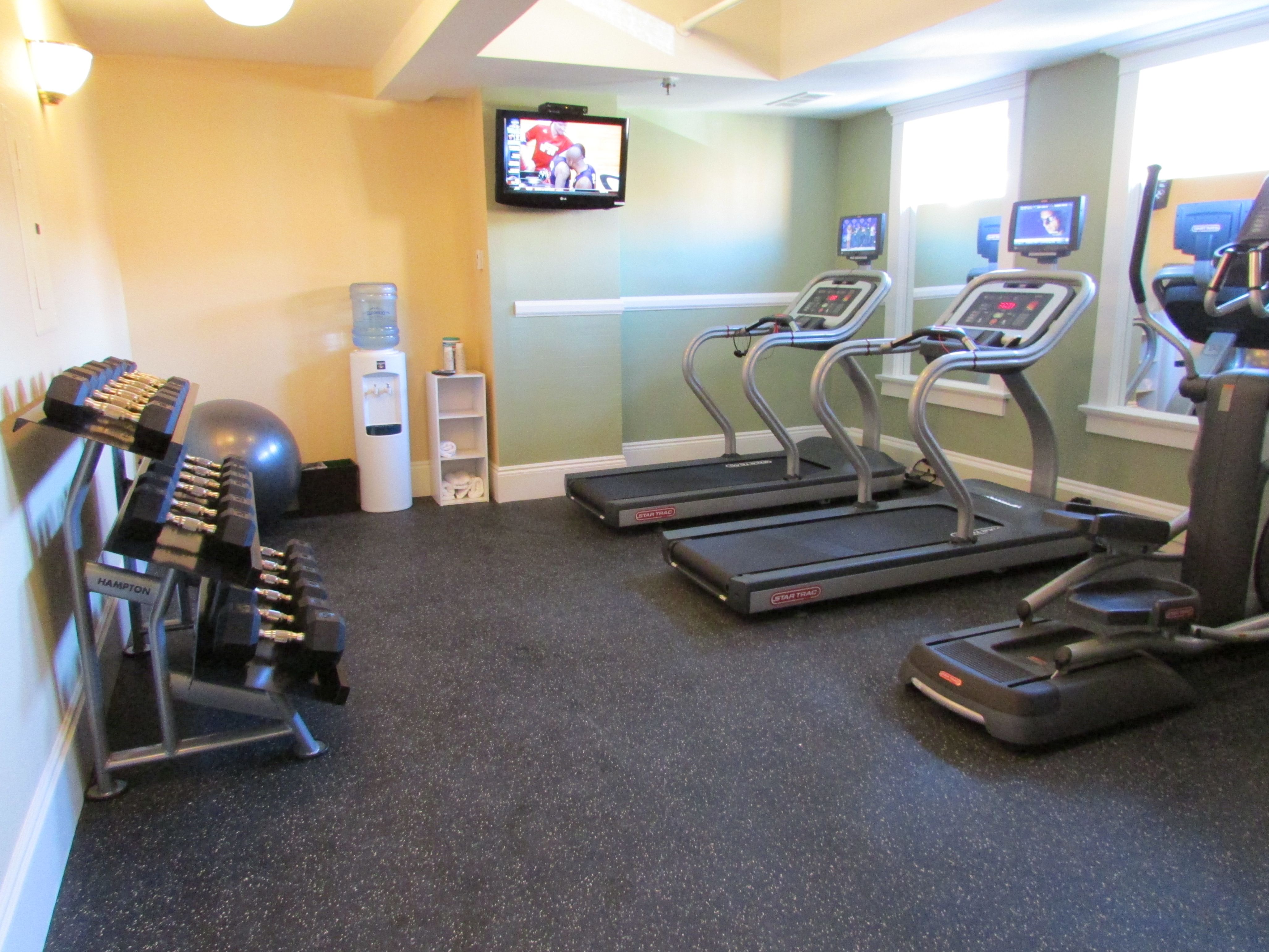 a gym with treadmills and exercise equipment