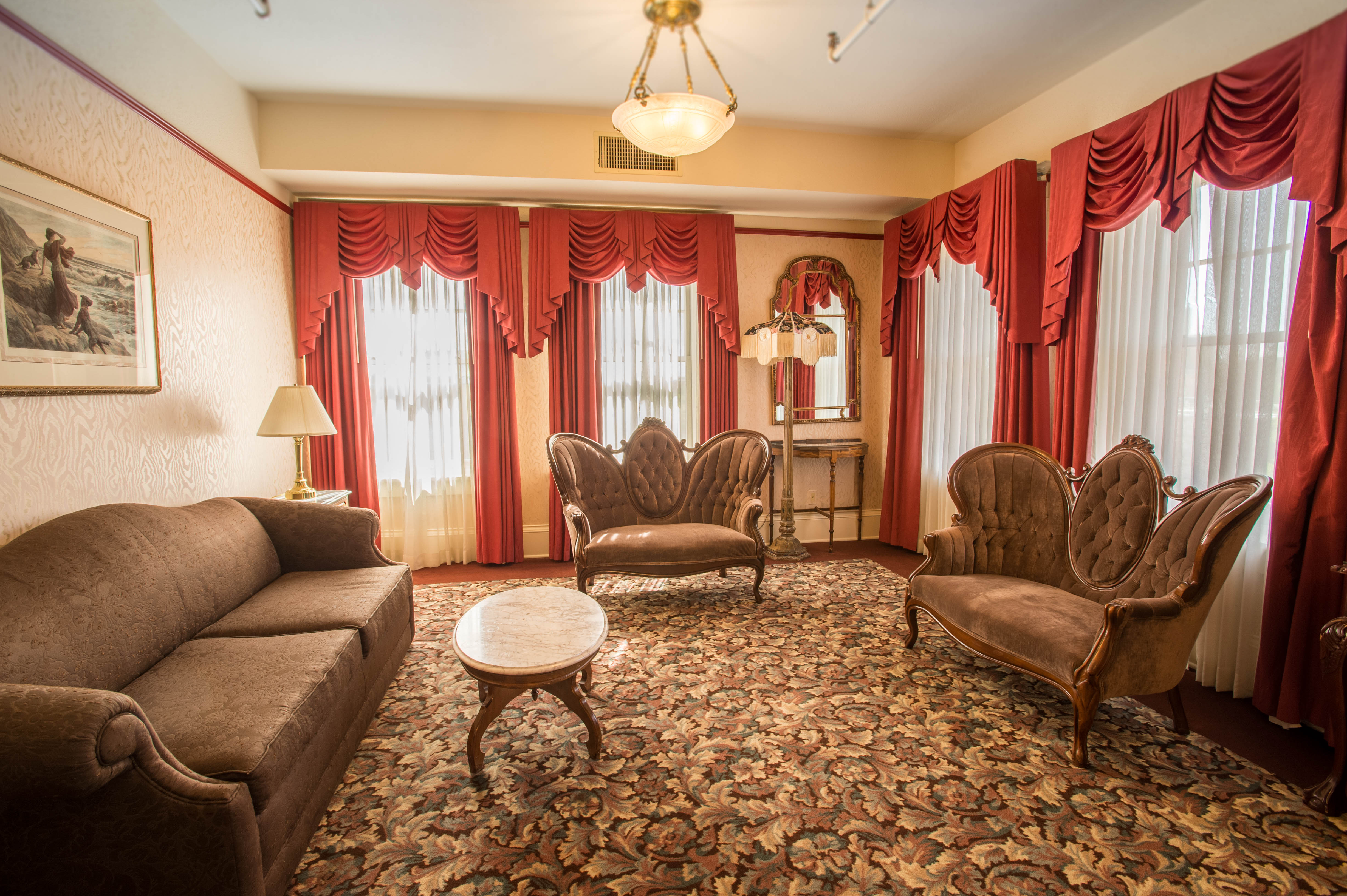 a room with a couch and chairs