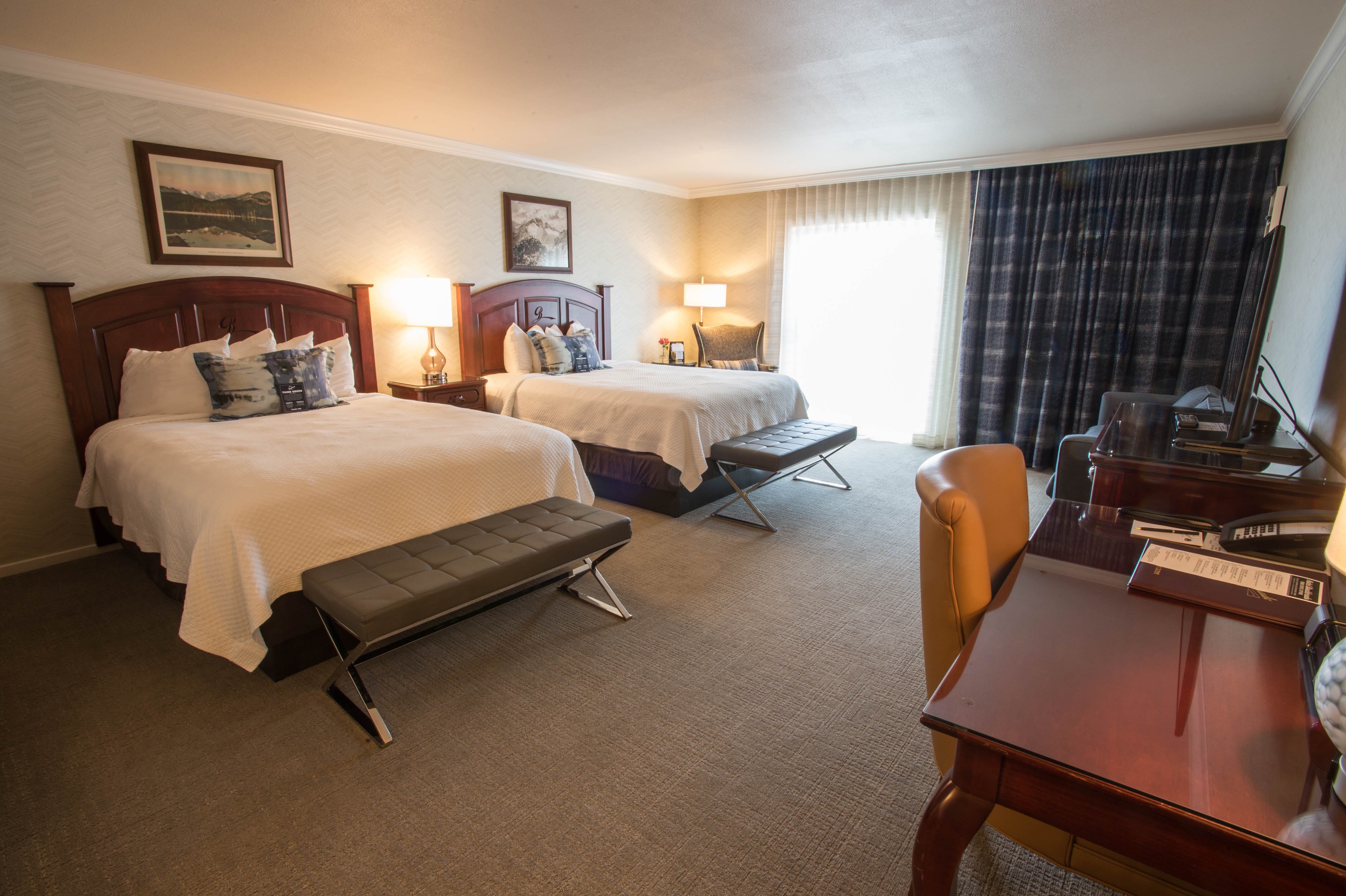 a room with two beds and a desk