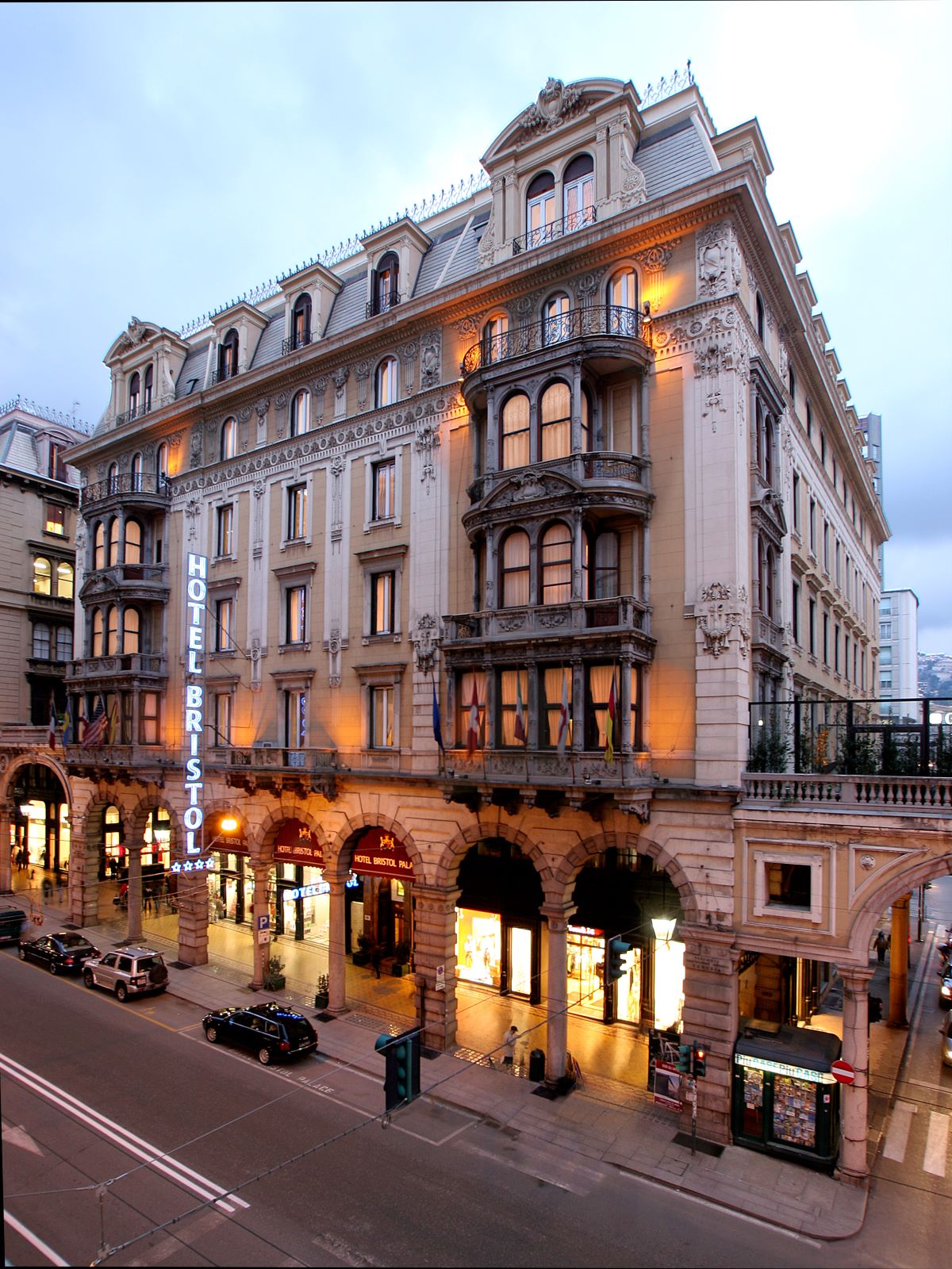 a building with many windows and a street with cars