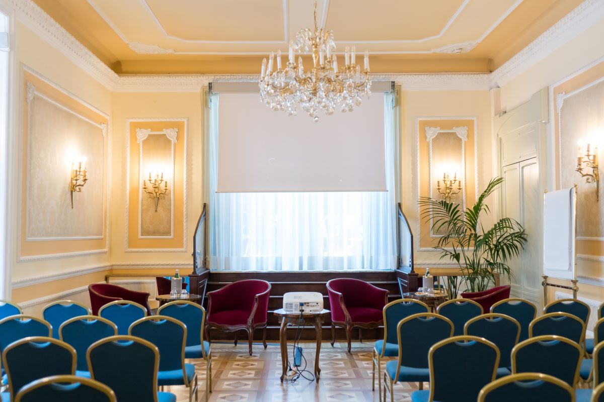 a room with chairs and chandelier
