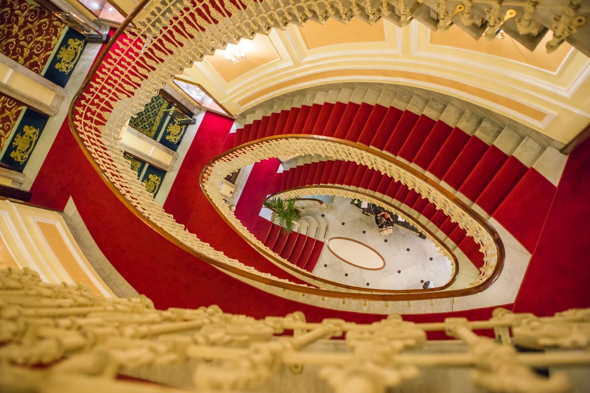 a spiral staircase with red carpet