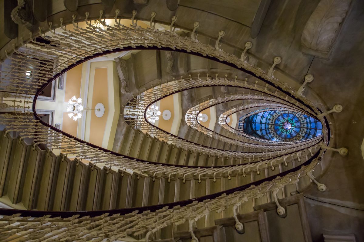 a spiral staircase with a stained glass window