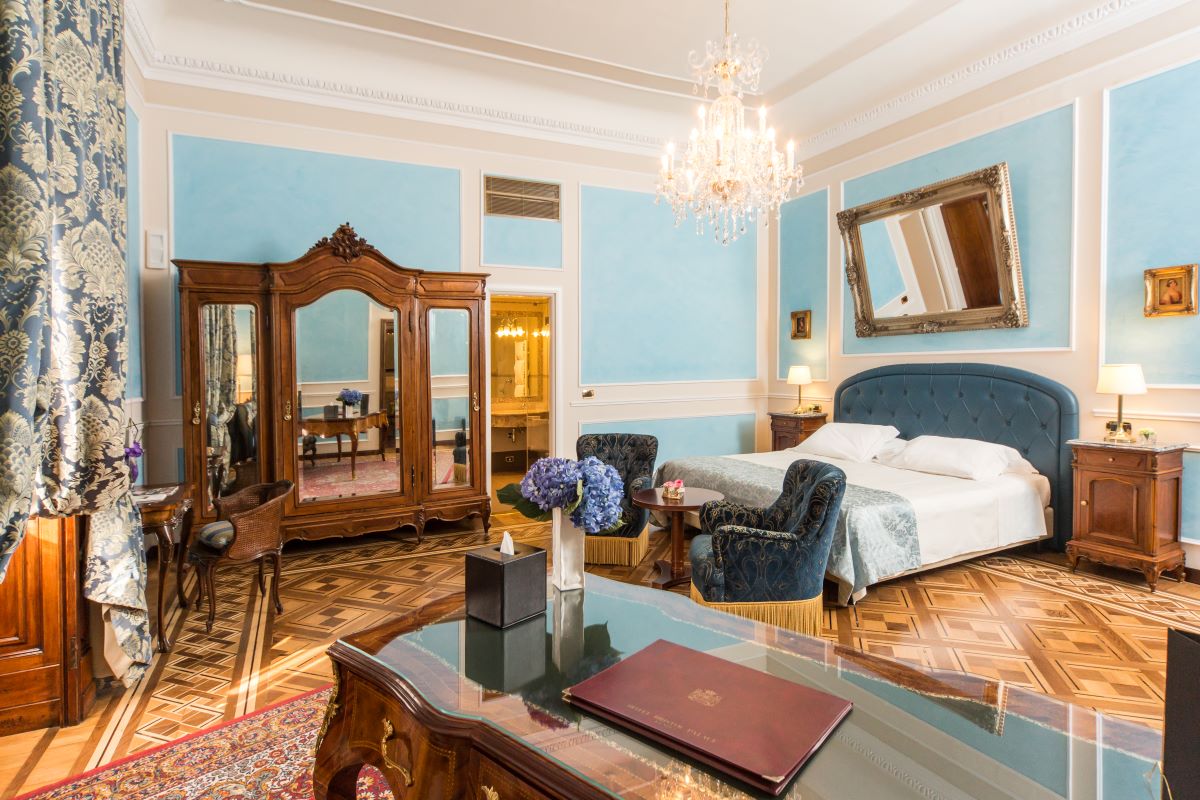 a bedroom with a mirror and a bed