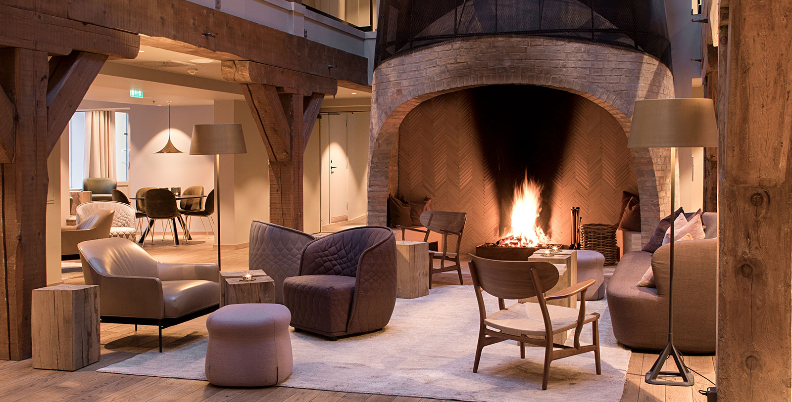 a room with a fireplace and chairs