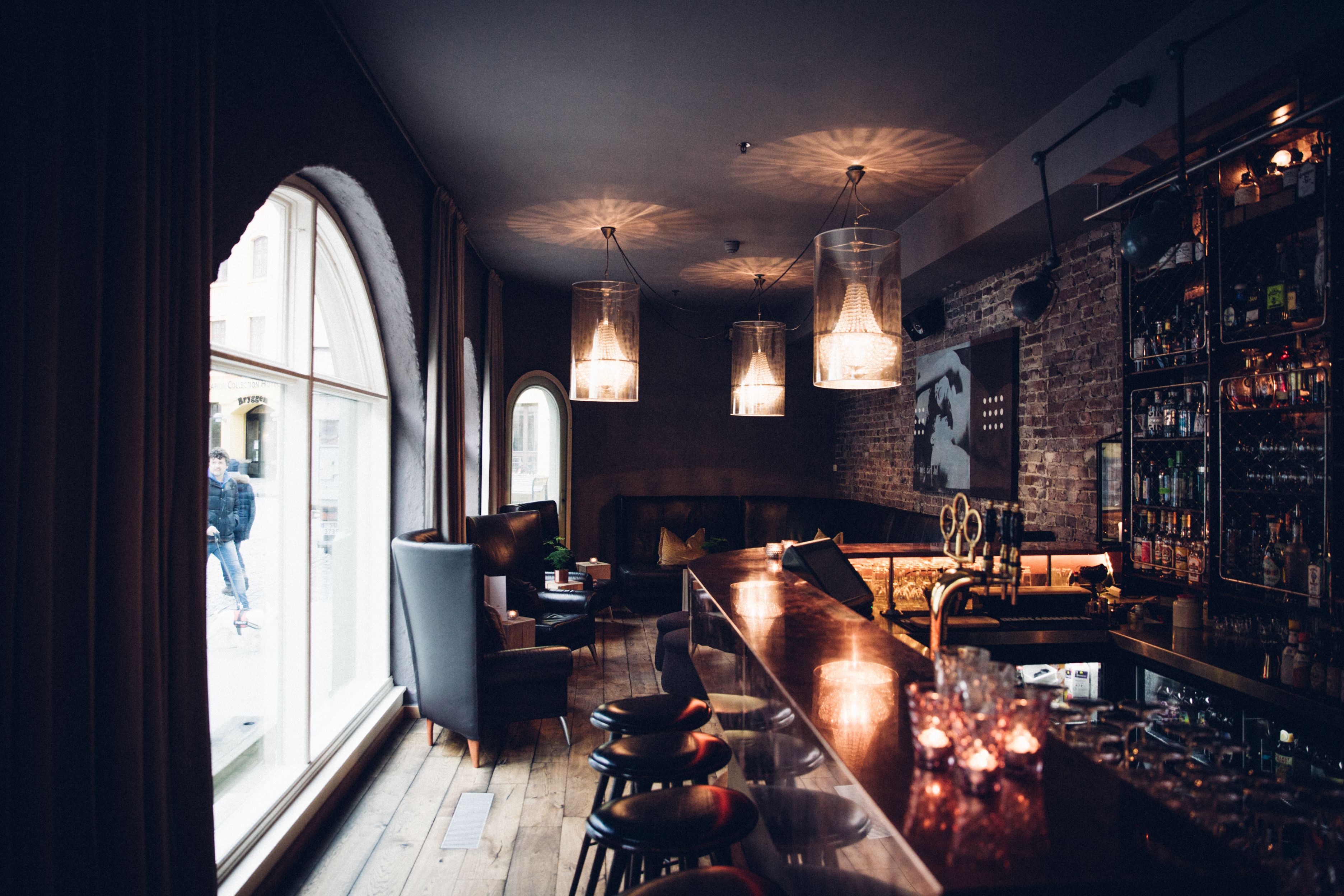 a bar with chairs and lights