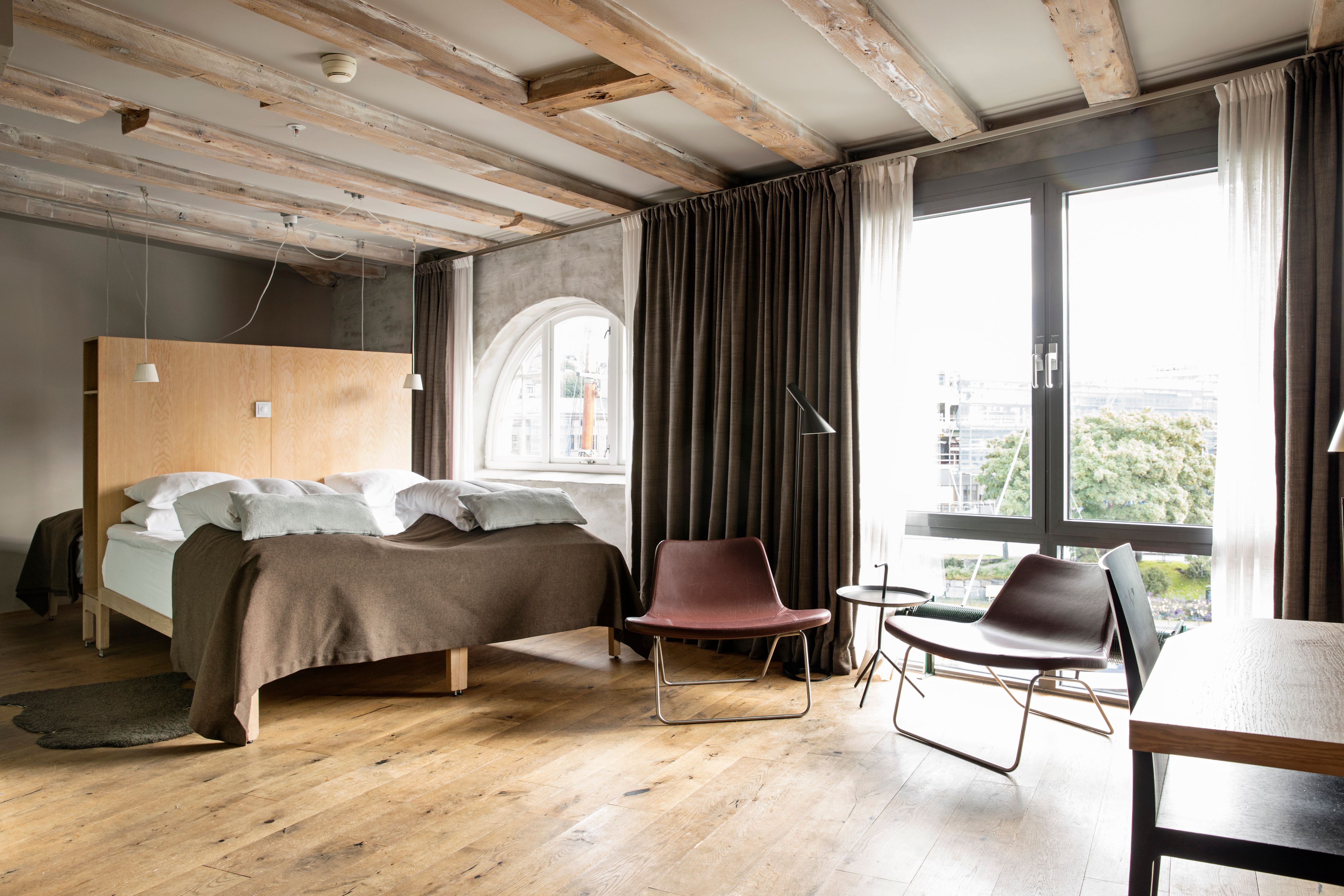 a bedroom with a bed and chairs